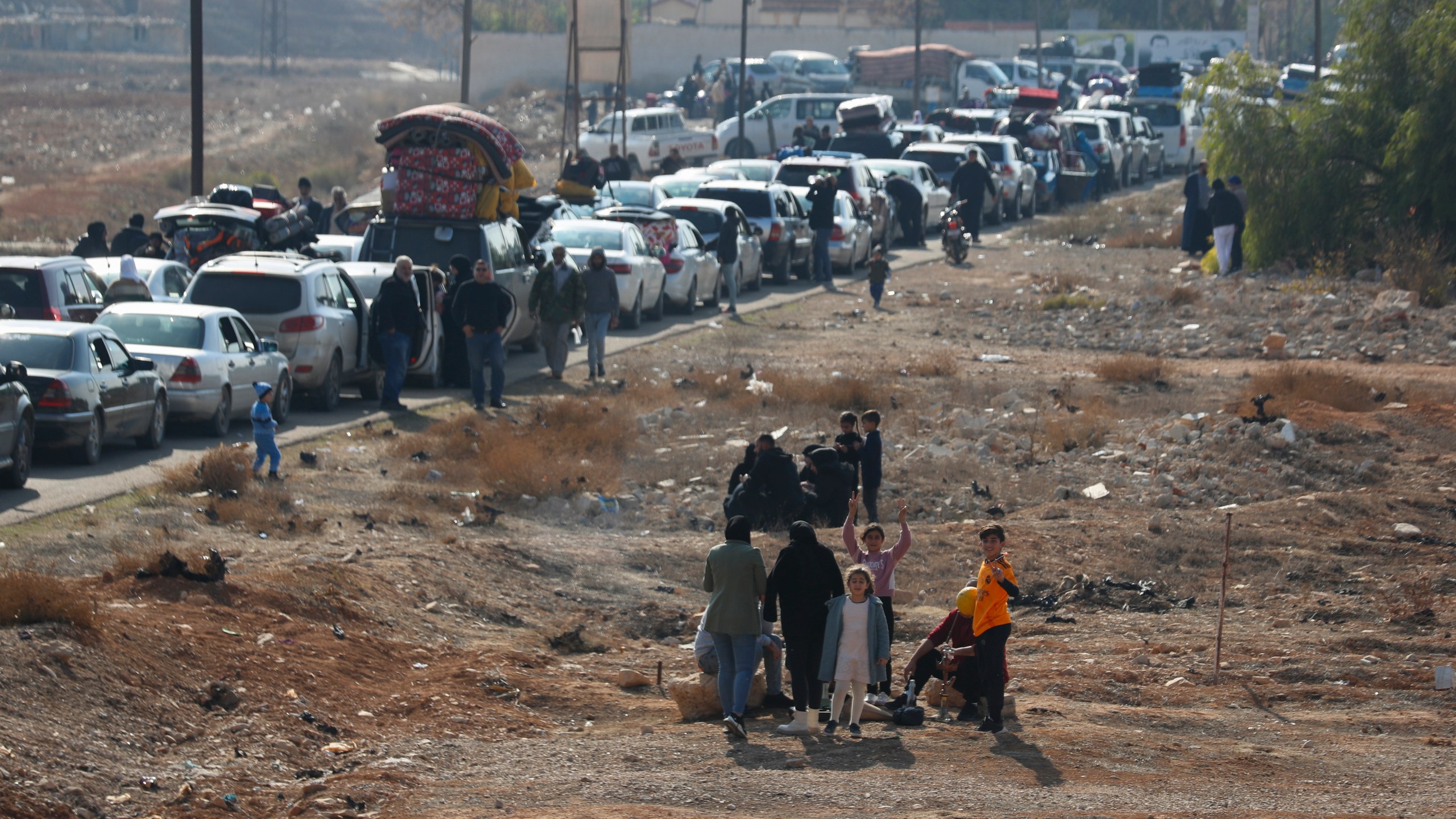 Lebanese families sit in traffic as they return to Lebanon through the Jousieh border crossing, Syria, Thursday, Nov. 28, 2024, following a ceasefire between Israel and Hezbollah that went into effect on Wednesday. (AP Photo/Omar Sanadiki)