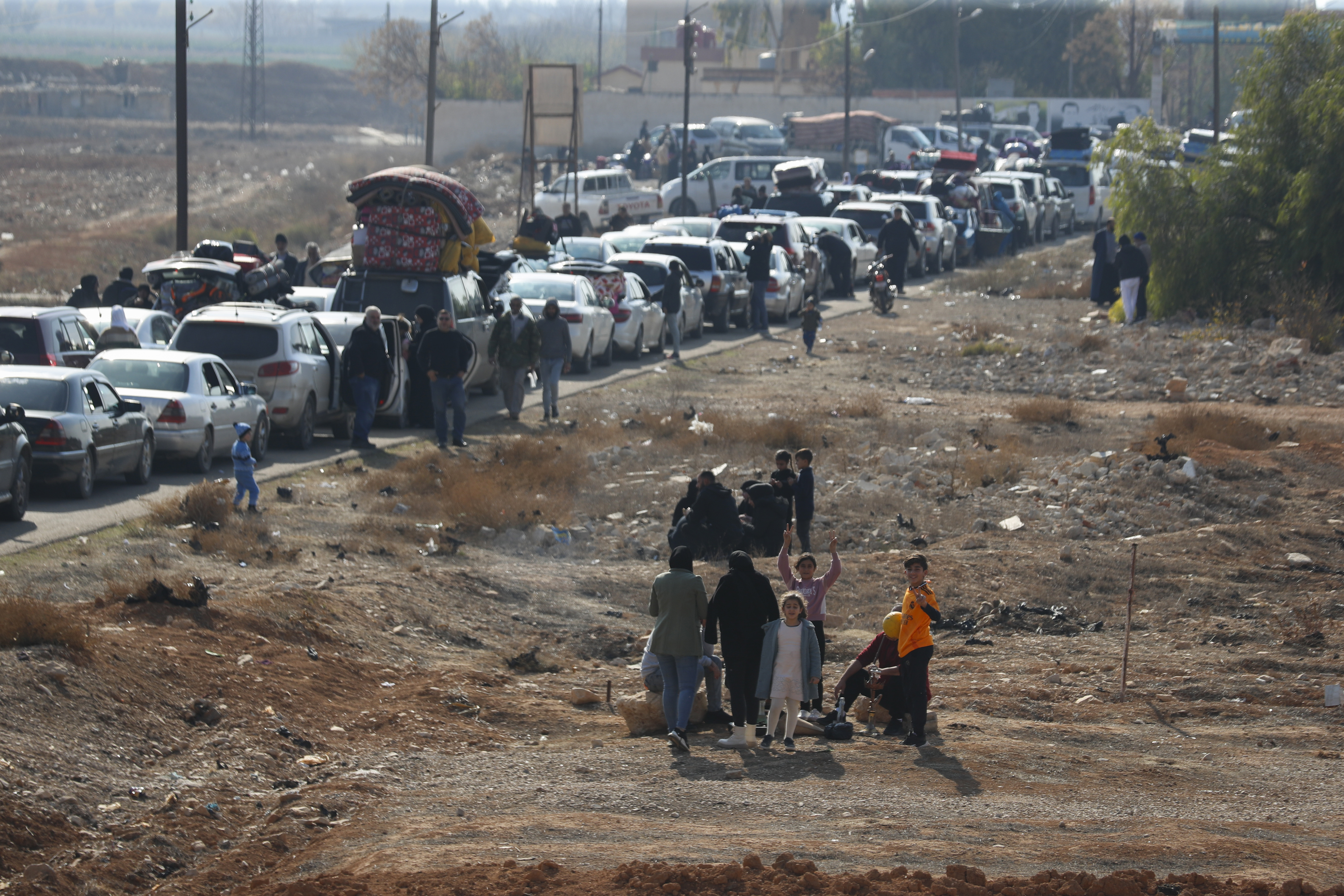 Lebanese families sit in traffic as they return to Lebanon through the Jousieh border crossing, Syria, Thursday, Nov. 28, 2024, following a ceasefire between Israel and Hezbollah that went into effect on Wednesday. (AP Photo/Omar Sanadiki)