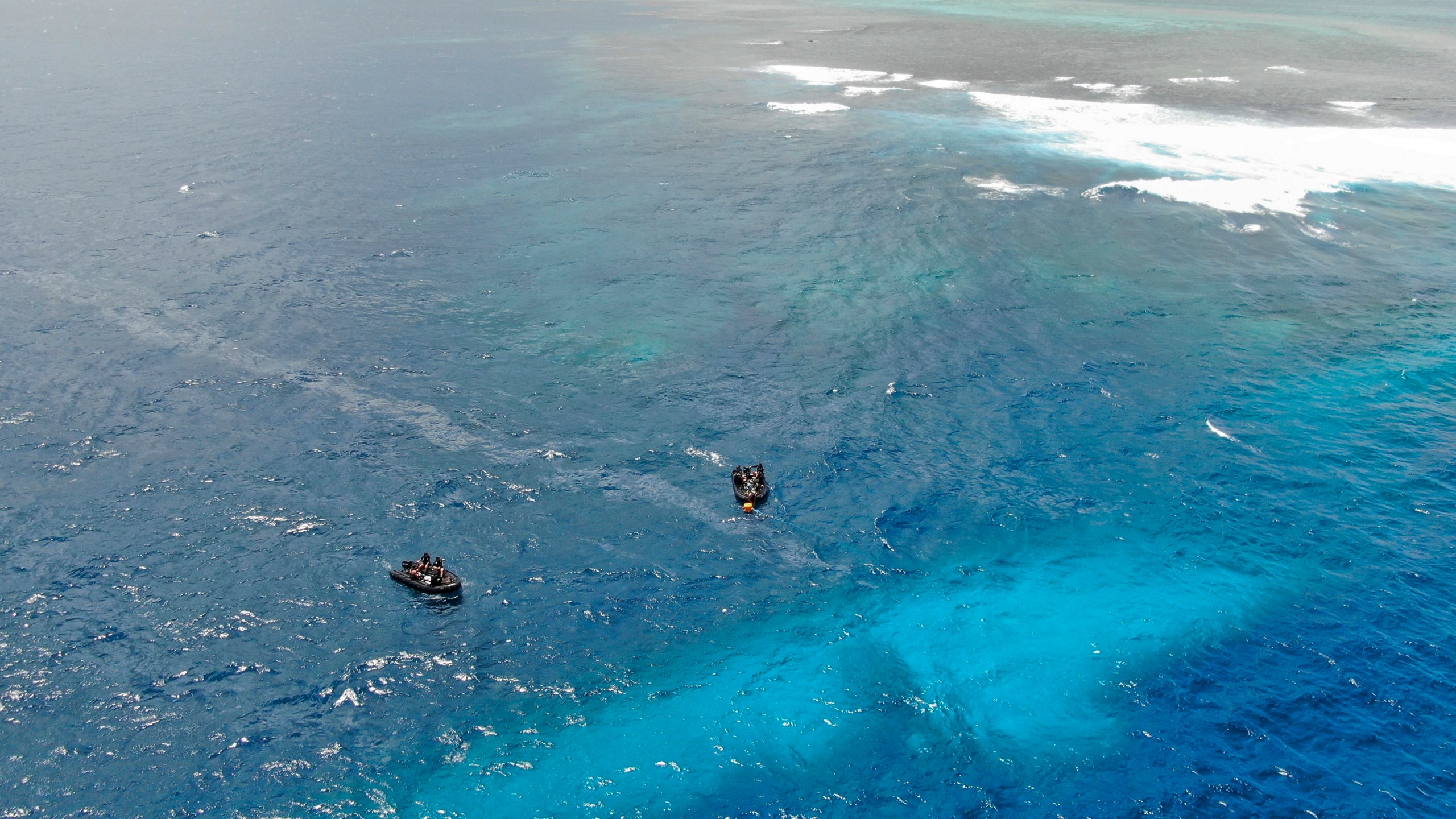 In this photo provided by the New Zealand Defence Force, divers survey the area around HMNZS Manawanui on the southern coast of Upulo, Samoa, after the Manawanui ran aground and sank on Oct. 6. (SGT Vanessa Parker/New Zealand Defence Force via AP)