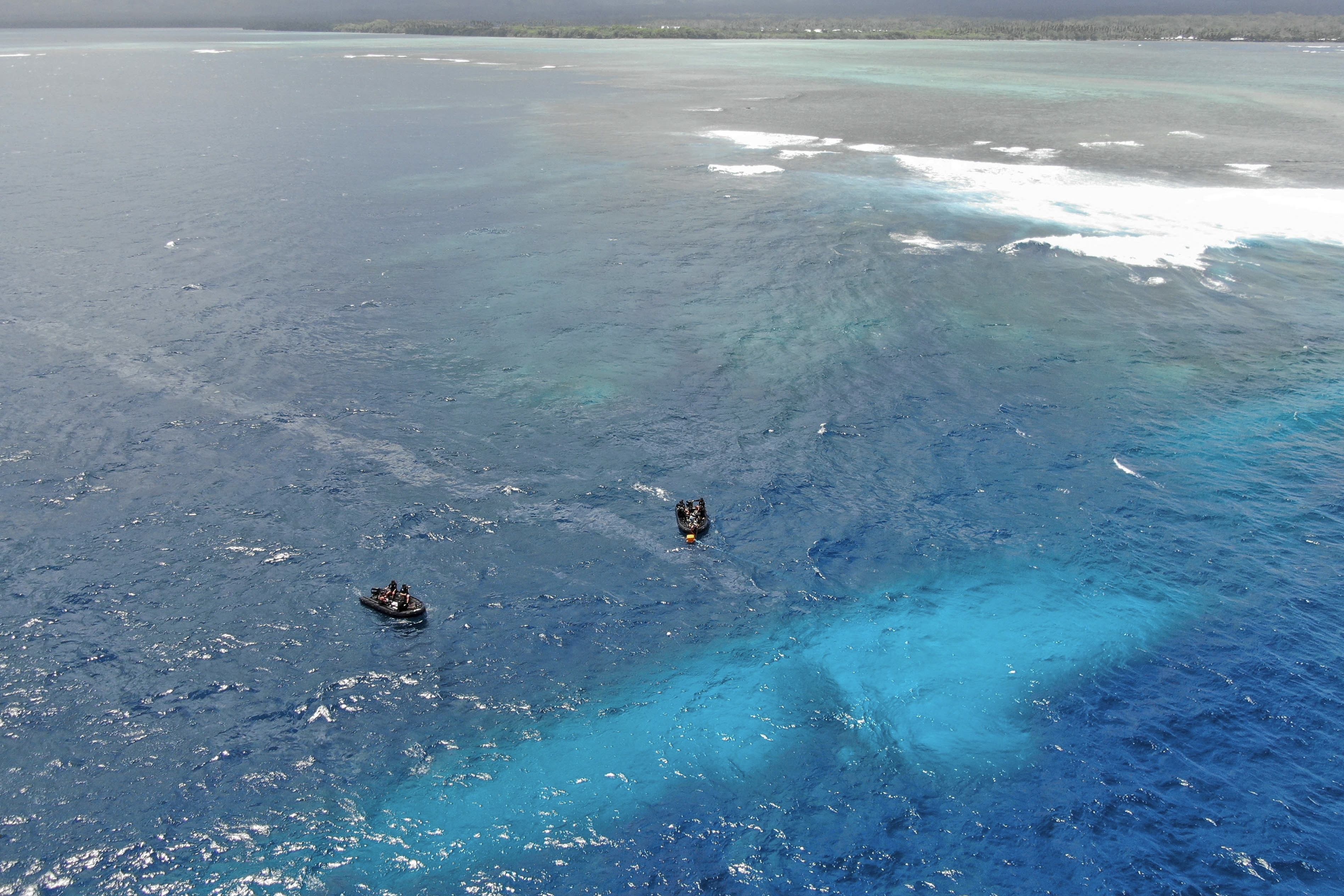 In this photo provided by the New Zealand Defence Force, divers survey the area around HMNZS Manawanui on the southern coast of Upulo, Samoa, after the Manawanui ran aground and sank on Oct. 6. (SGT Vanessa Parker/New Zealand Defence Force via AP)