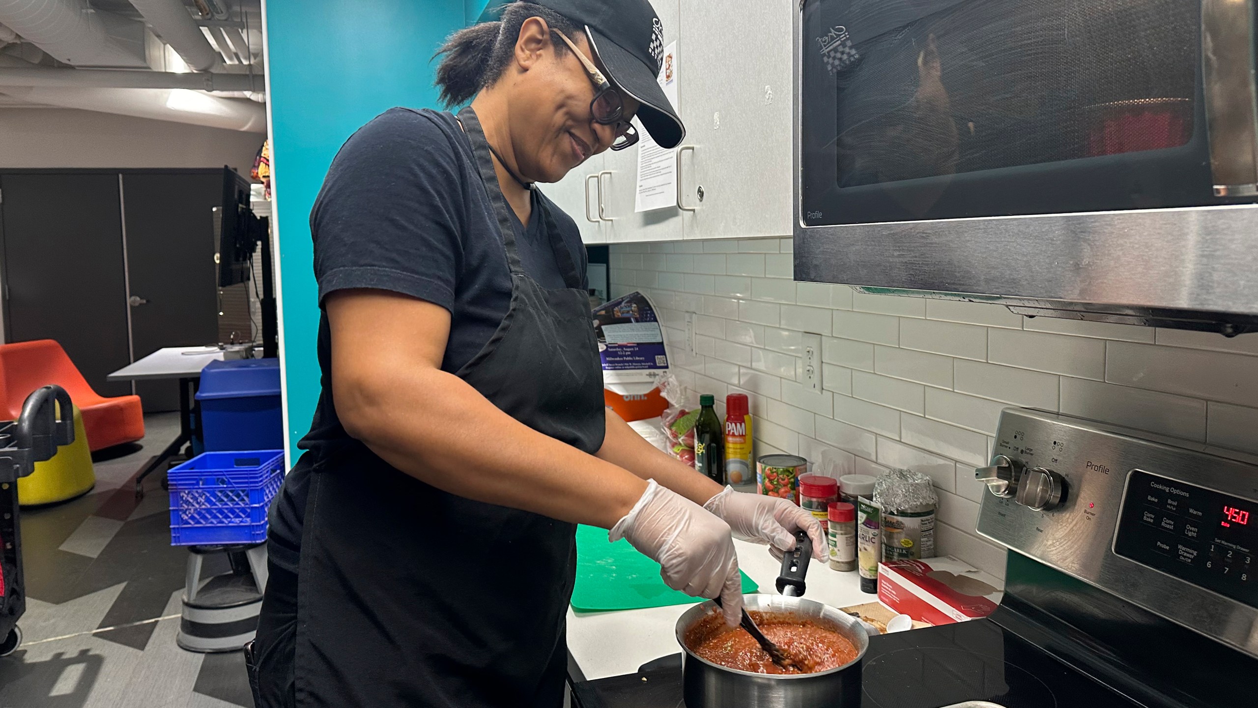 Chef Sharrie Agee prepares food as part of the Milwaukee Public Library’s Snack Hack program for kids on Nov. 19, 2024, Milwaukee. (AP Photo/Devi Shastri)