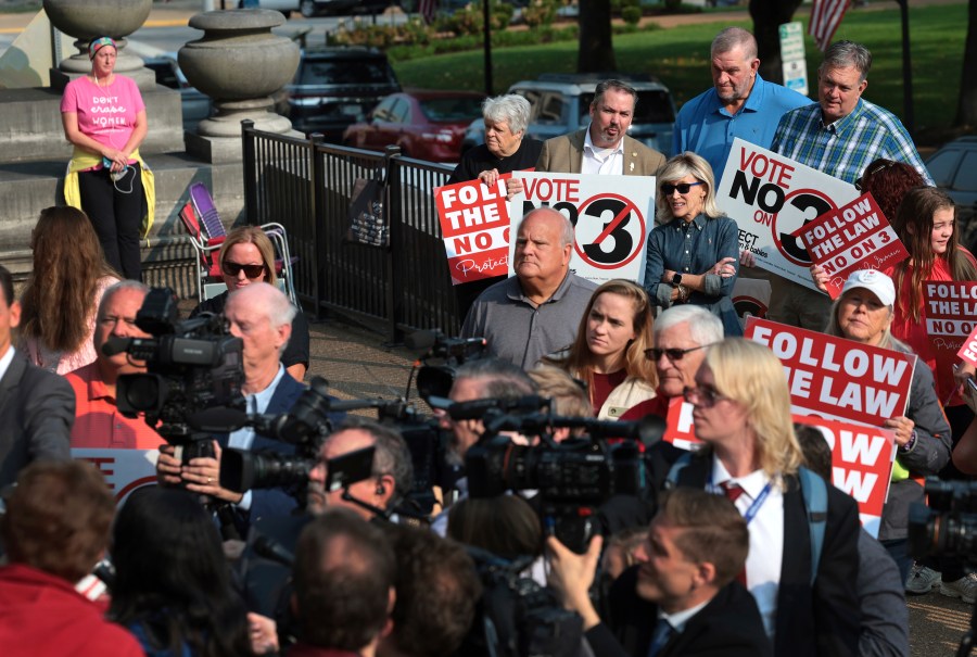 FILE - Abortion opponents watch and pray as members of the media interview attorney Mary Catherine Martin of the conservative Thomas More Society, after Missouri's Supreme Court heard arguments over whether an abortion-rights amendment should go before voters this year on Sept. 10, 2024 in Jefferson City, Mo. (Robert Cohen/St. Louis Post-Dispatch via AP, File)/St. Louis Post-Dispatch via AP)