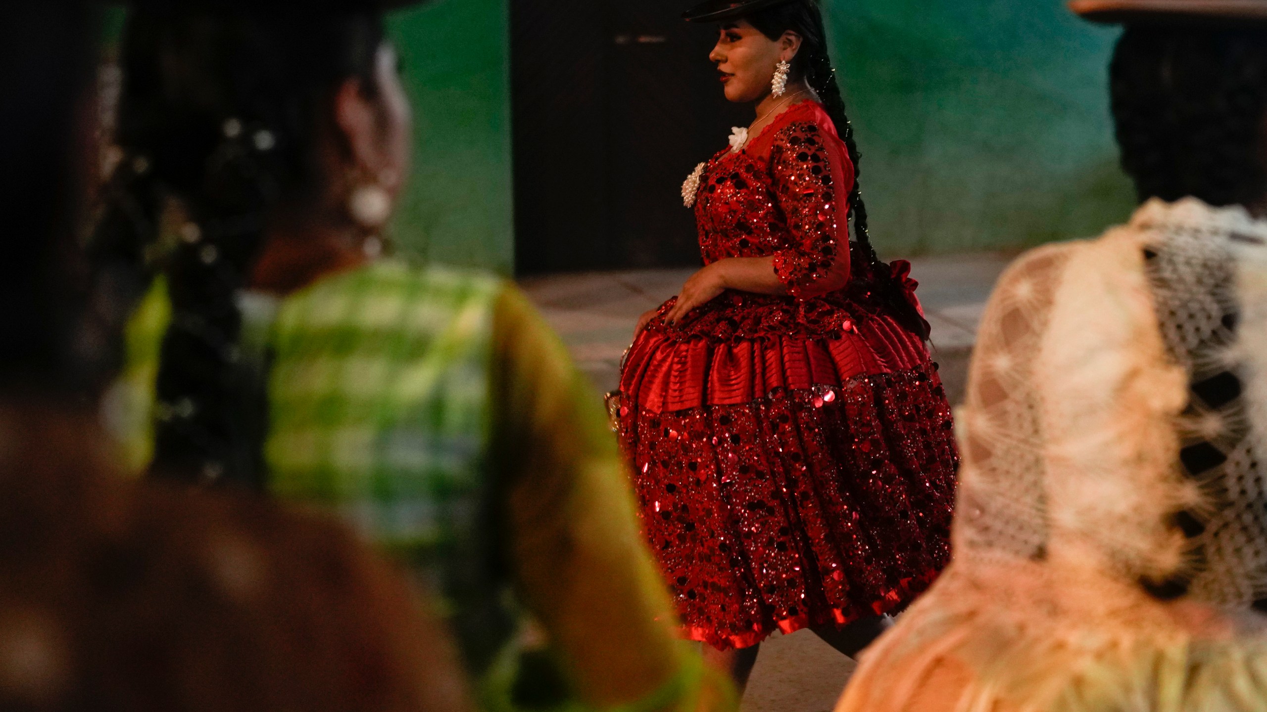 Women model creations by a local designer at a Chola fashion show, promoting the Andean style and beauty of Aymara women, in Viacha, Bolivia, Friday, Nov. 29, 2024. (AP Photo/Juan Karita)