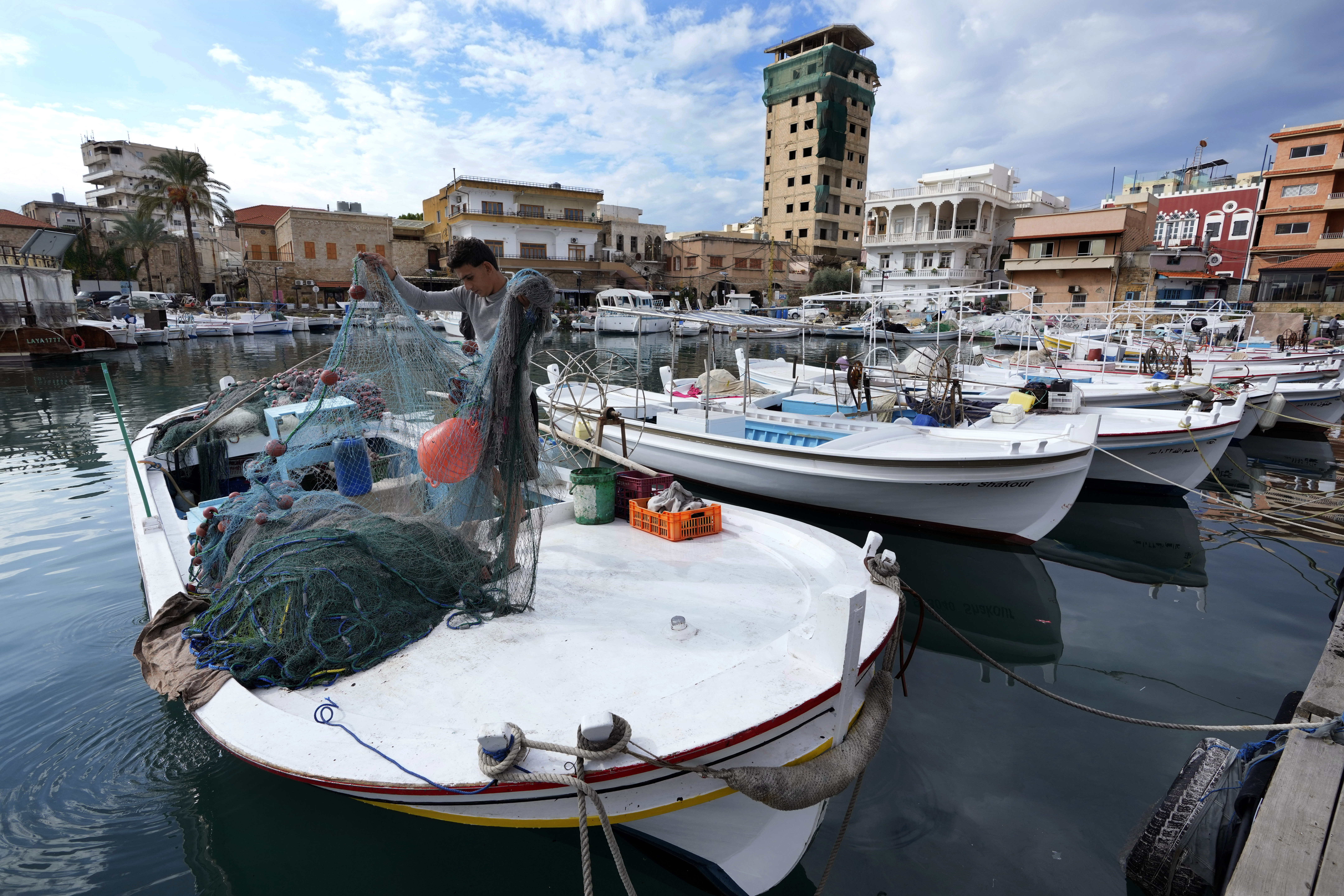 A fisherman prepares his nets for fishing, in Tyre, southern Lebanon, where the ceasefire between Israel and Hezbollah brought hope for normality back to many in southern Lebanon on Friday, Nov. 29, 2024. (AP Photo/Hussein Malla)