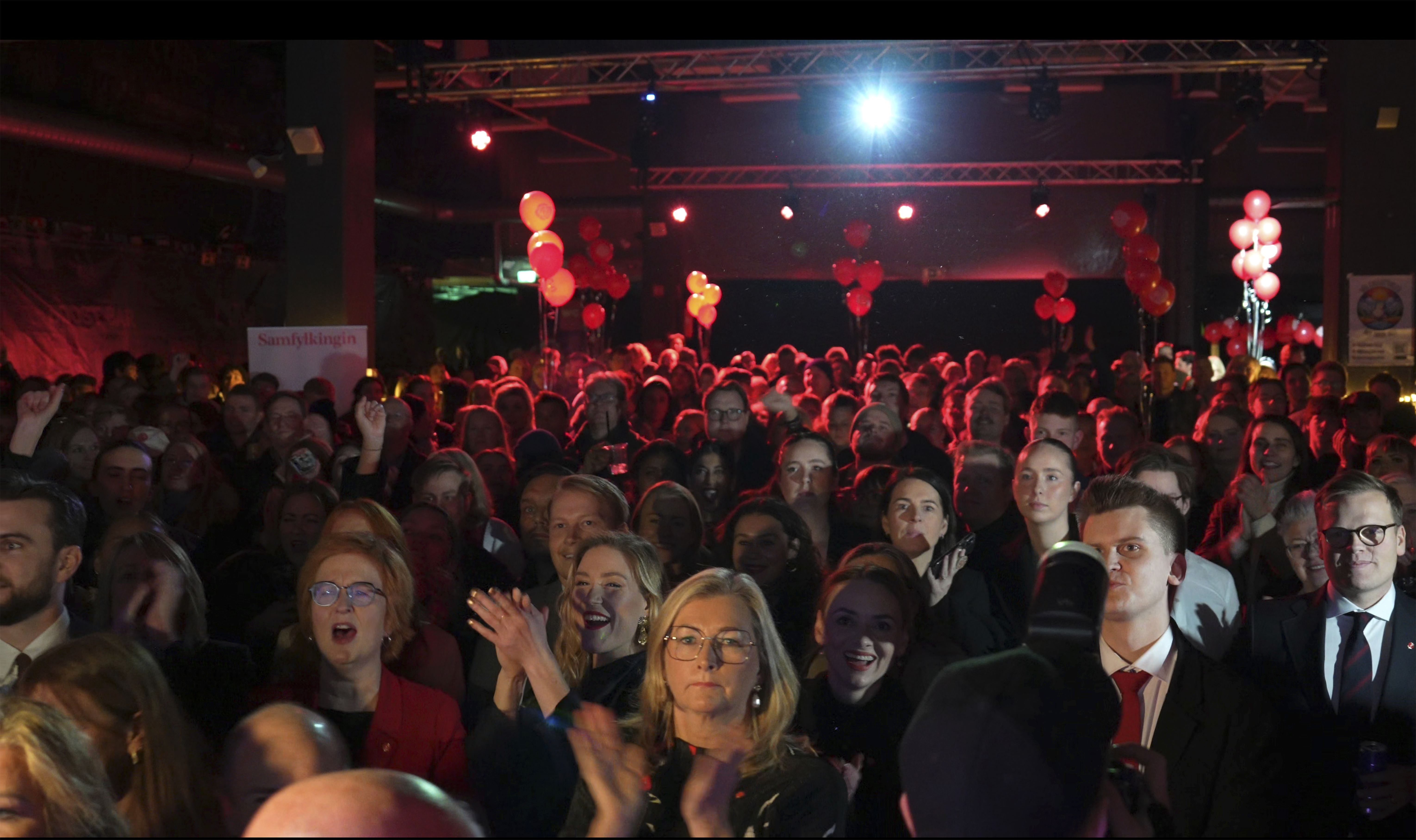 Supporters attend the Samfylkingin Social Democratic Party celebration party following the closure of the polling stations, in Reykjavik, Saturday Nov. 30, 2024. (AP Photo/Marco di Marco)