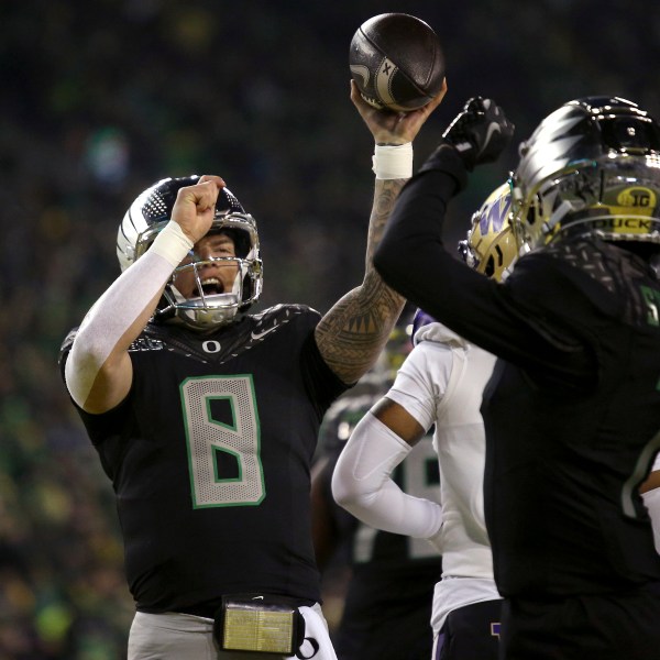 Oregon quarterback Dillon Gabriel (8) and Oregon wide receiver Evan Stewart (7) celebrate after Gabriel's touchdown during an NCAA college football game against Washington, Saturday, Nov. 30, 2024, in Eugene, Ore. (AP Photo/Lydia Ely)