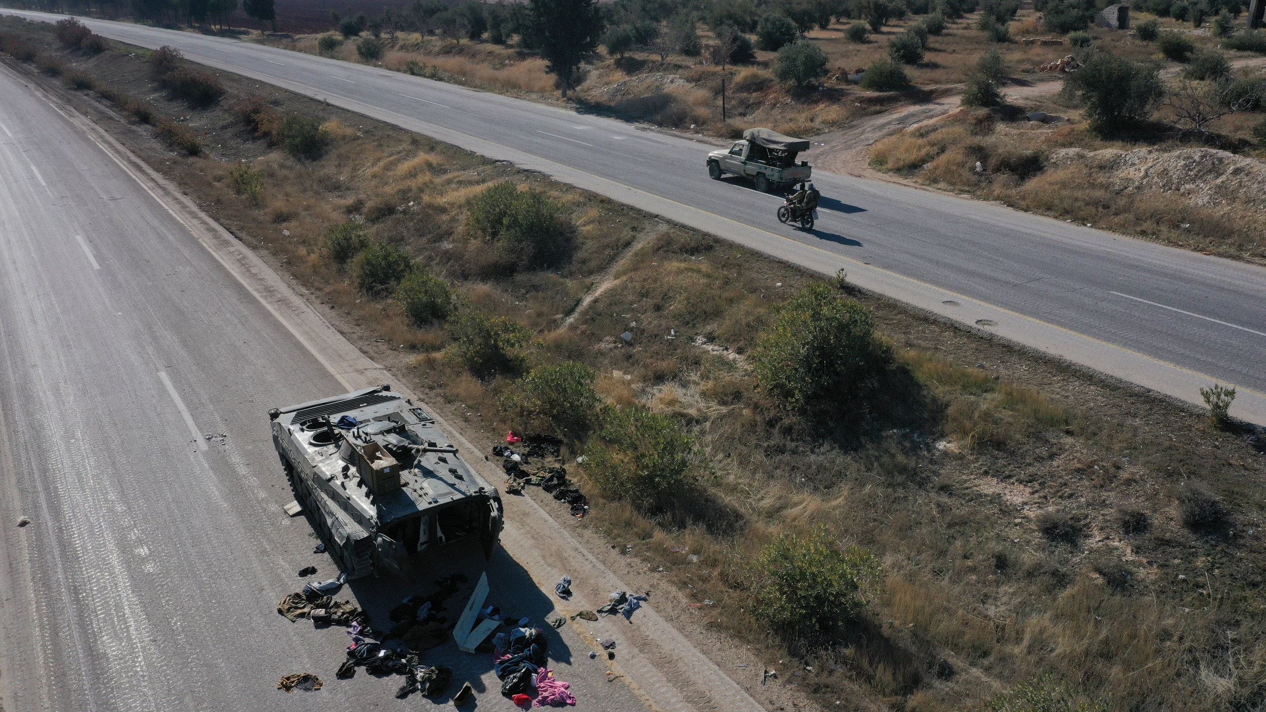 A Syrian army armoured vehicle sits abandoned on a highway in the outskirts of Khan Sheikhoun, southwest of Aleppo, Sunday, Dec. 1, 2024. Syrian opposition insurgency launched a campaign on Wednesday with a two-pronged attack on Aleppo and the countryside around Idlib.(AP Photo/Ghaith Alsayed)