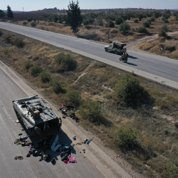 A Syrian army armoured vehicle sits abandoned on a highway in the outskirts of Khan Sheikhoun, southwest of Aleppo, Sunday, Dec. 1, 2024. Syrian opposition insurgency launched a campaign on Wednesday with a two-pronged attack on Aleppo and the countryside around Idlib.(AP Photo/Ghaith Alsayed)