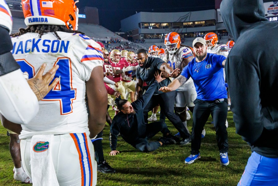 Florida State and Florida players scuffle at midfield after an NCAA college football game Saturday, Nov. 30, 2024, in Tallahassee, Fla. (AP Photo/Colin Hackley)