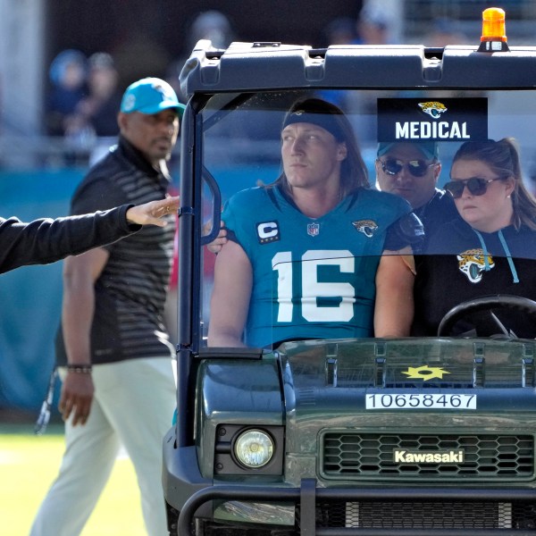 Jacksonville Jaguars quarterback Trevor Lawrence (16) leaves the field on a cart after getting injured on a late hit by Houston Texans linebacker Azeez Al-Shaair during the first half of an NFL football game Sunday, Dec. 1, 2024, in Jacksonville, Fla. (AP Photo/John Raoux)