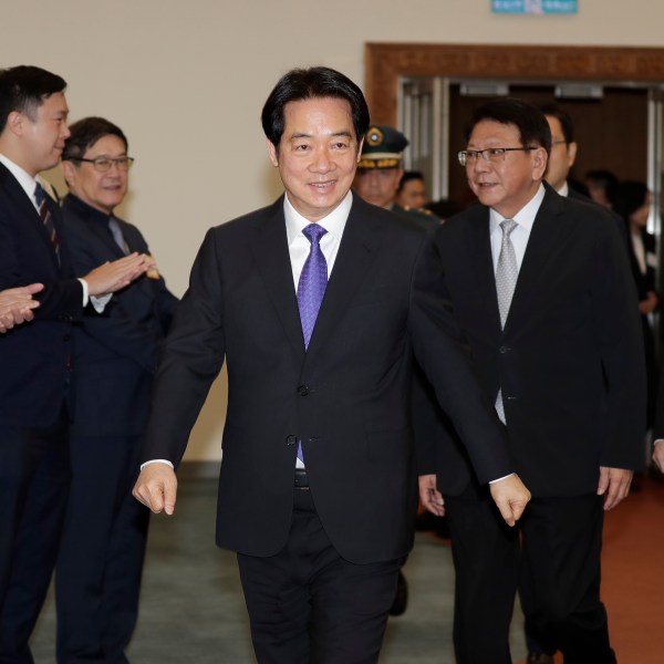 Taiwanese President Lai Ching-te smiles to the media as he departs for South Pacific at Taoyuan International Airport in Taoyuan, Taiwan, Saturday, Nov. 30, 2024. Lai leave Taiwan on Saturday on a weeklong trip to visit the Marshall Islands, Tuvalu and Palau 'X three diplomatic allies of the self-governed island. (AP Photo/Chiang Ying-ying)