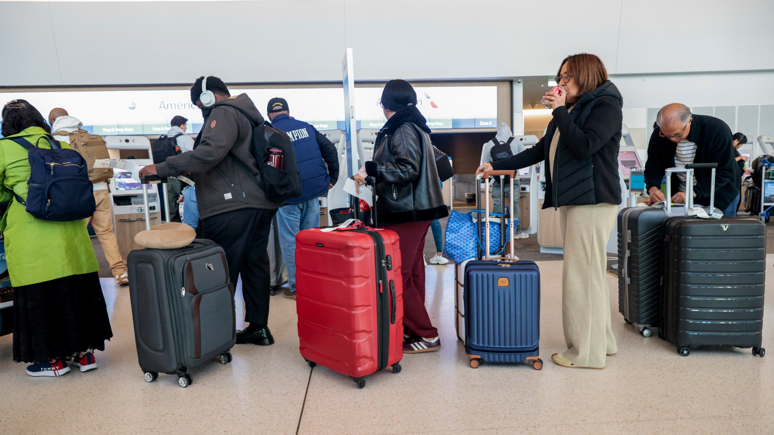 Travelers line up to check in their bags into San Francisco International Airport on Wednesday, Nov. 27, 2024. (Santiago Mejia/San Francisco Chronicle via AP)