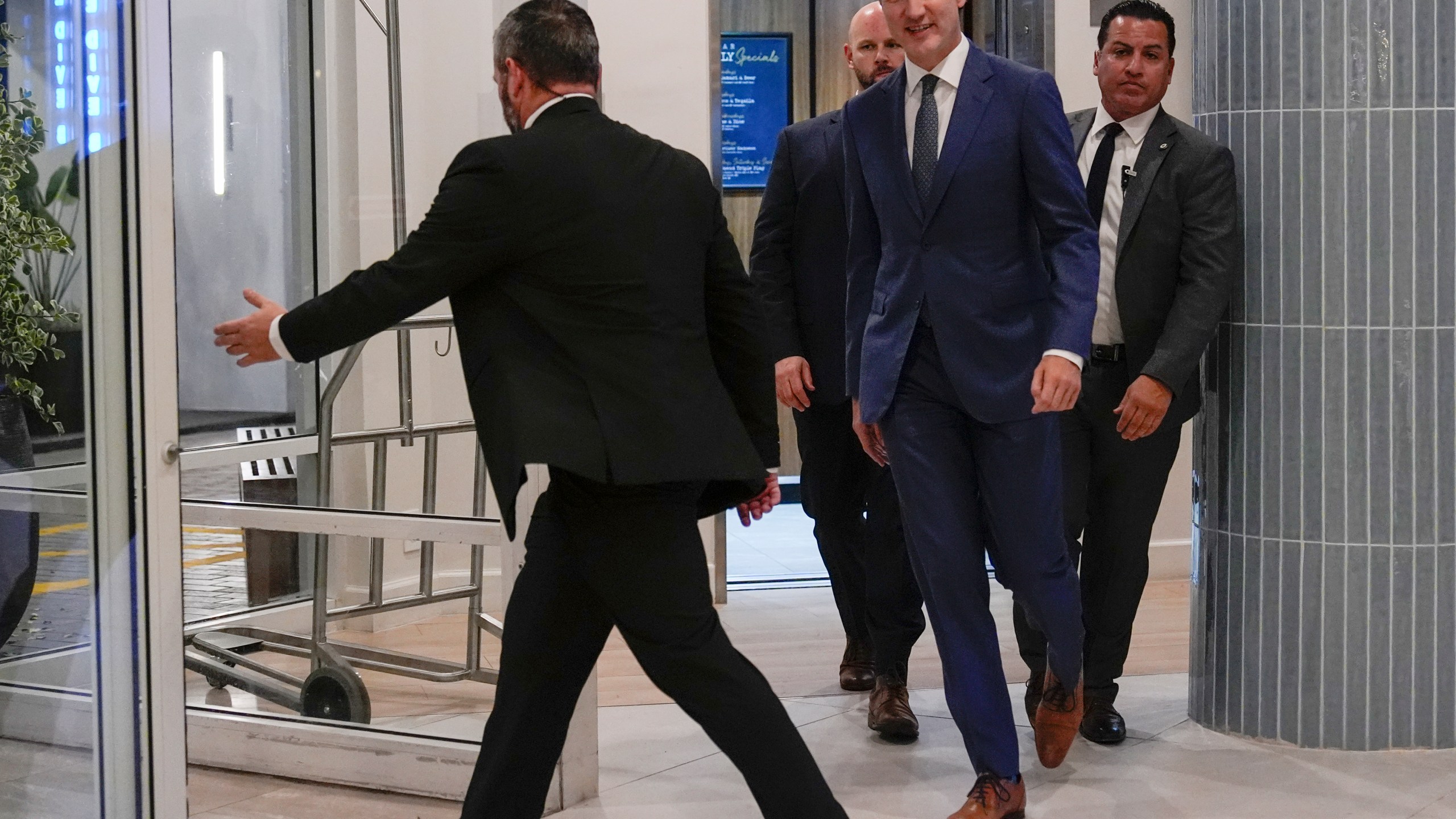 Canadian Prime Minister Justin Trudeau walks through the lobby of the Delta Hotel by Marriott, Friday, Nov. 29, 2024, in West Palm Beach, Fla. (AP Photo/Carolyn Kaster)