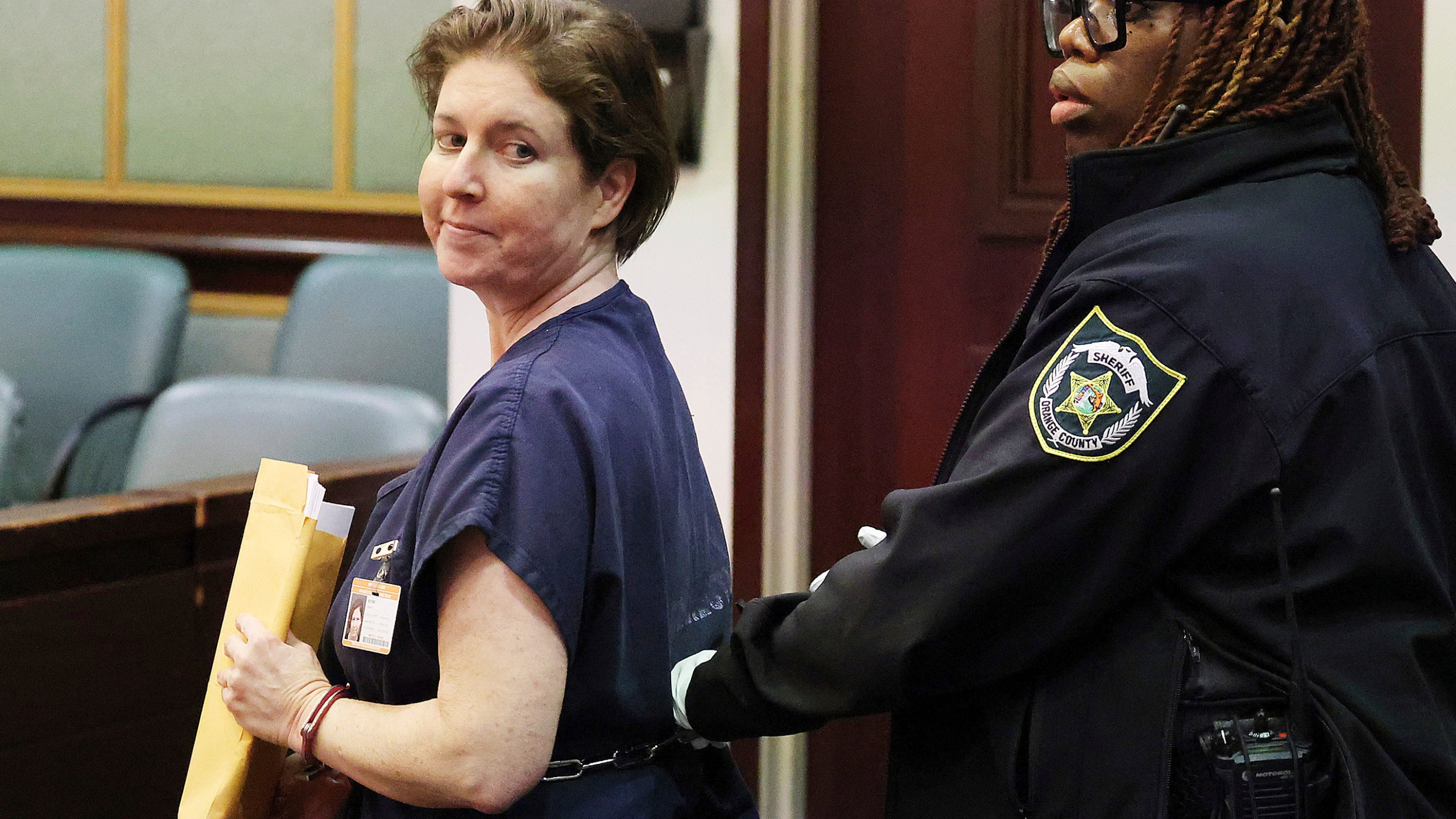 Sarah Boone smiles as she is led off in handcuffs in a courtroom of the Orange County Courthouse in Orlando, Florida, on Monday, Dec. 2, 2024. (Stephen M. Dowell/Orlando Sentinel via AP)