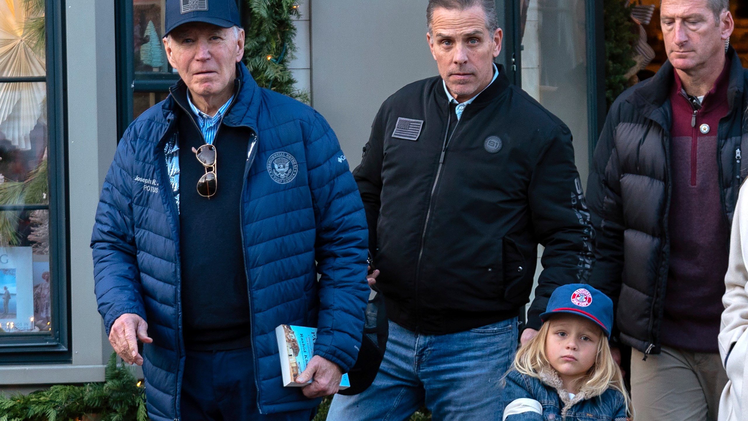 President Joe Biden accompanied by his son Hunter Biden and his grandson Beau leave a book store as they walk in downtown Nantucket Mass., Friday, Nov. 29, 2024. (AP Photo/Jose Luis Magana)