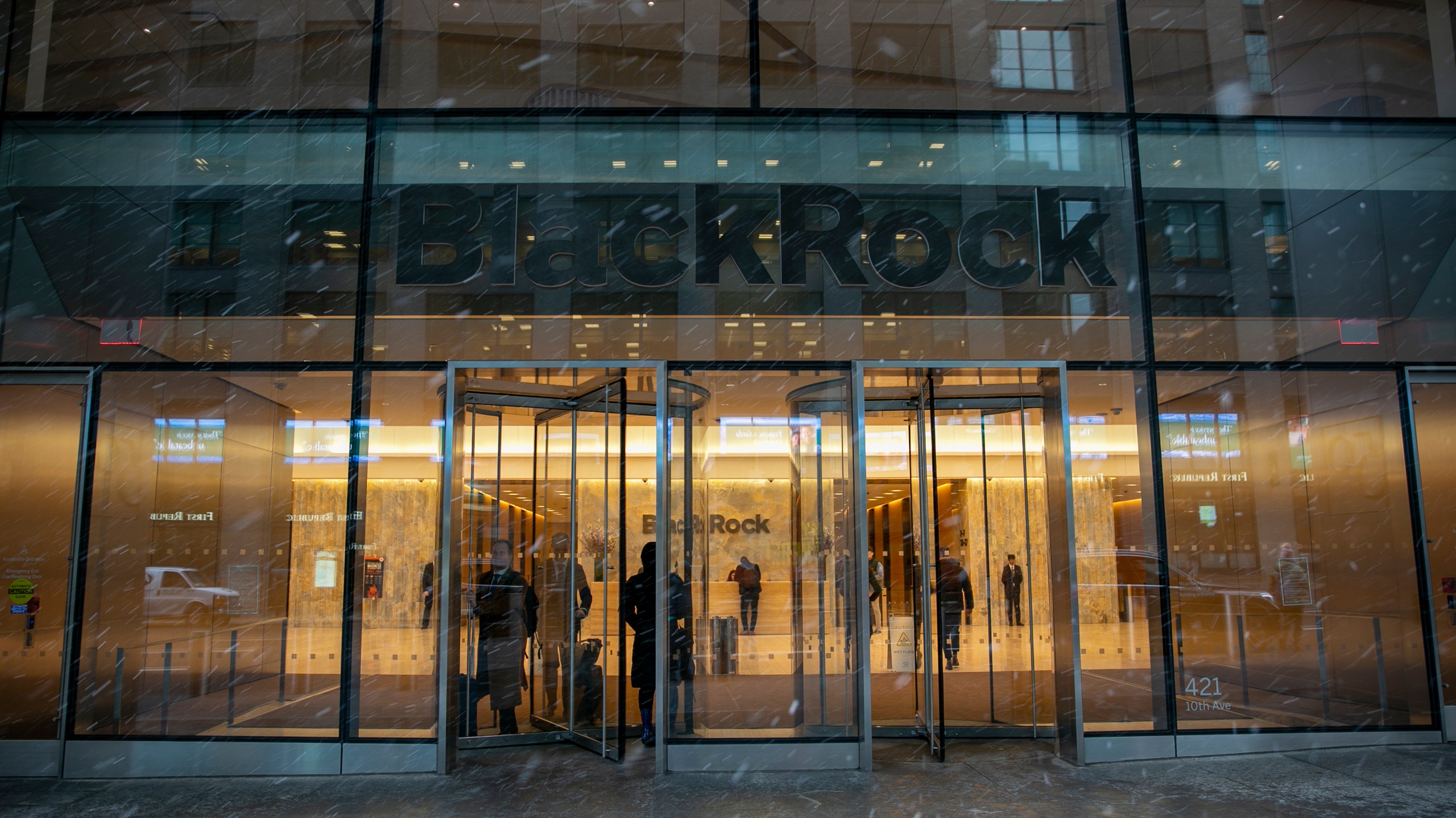 FILE - People walk in and out of the BlackRock investment company building in New York on March 14, 2023. (AP Photo/Ted Shaffrey, file)