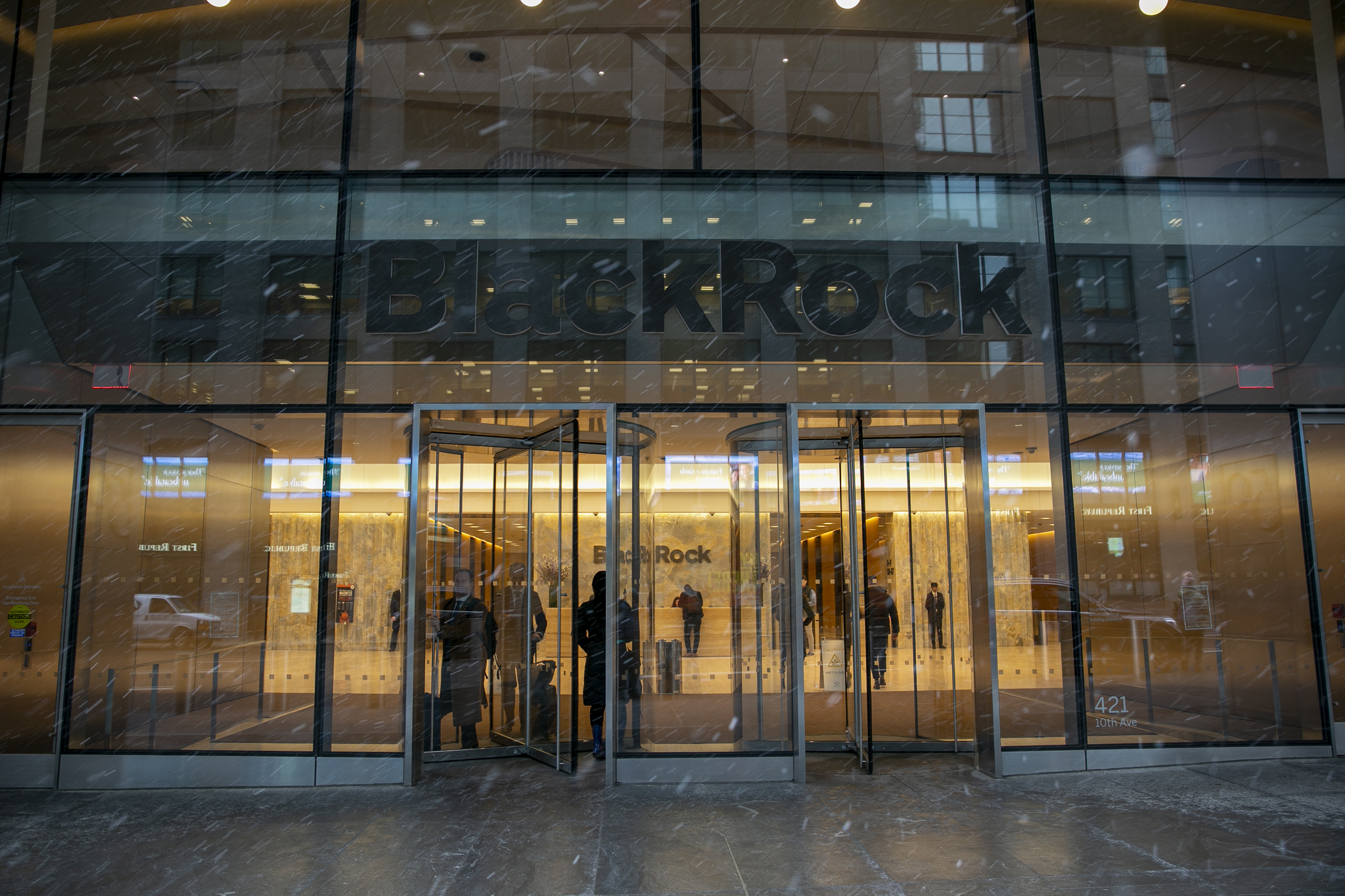 FILE - People walk in and out of the BlackRock investment company building in New York on March 14, 2023. (AP Photo/Ted Shaffrey, file)