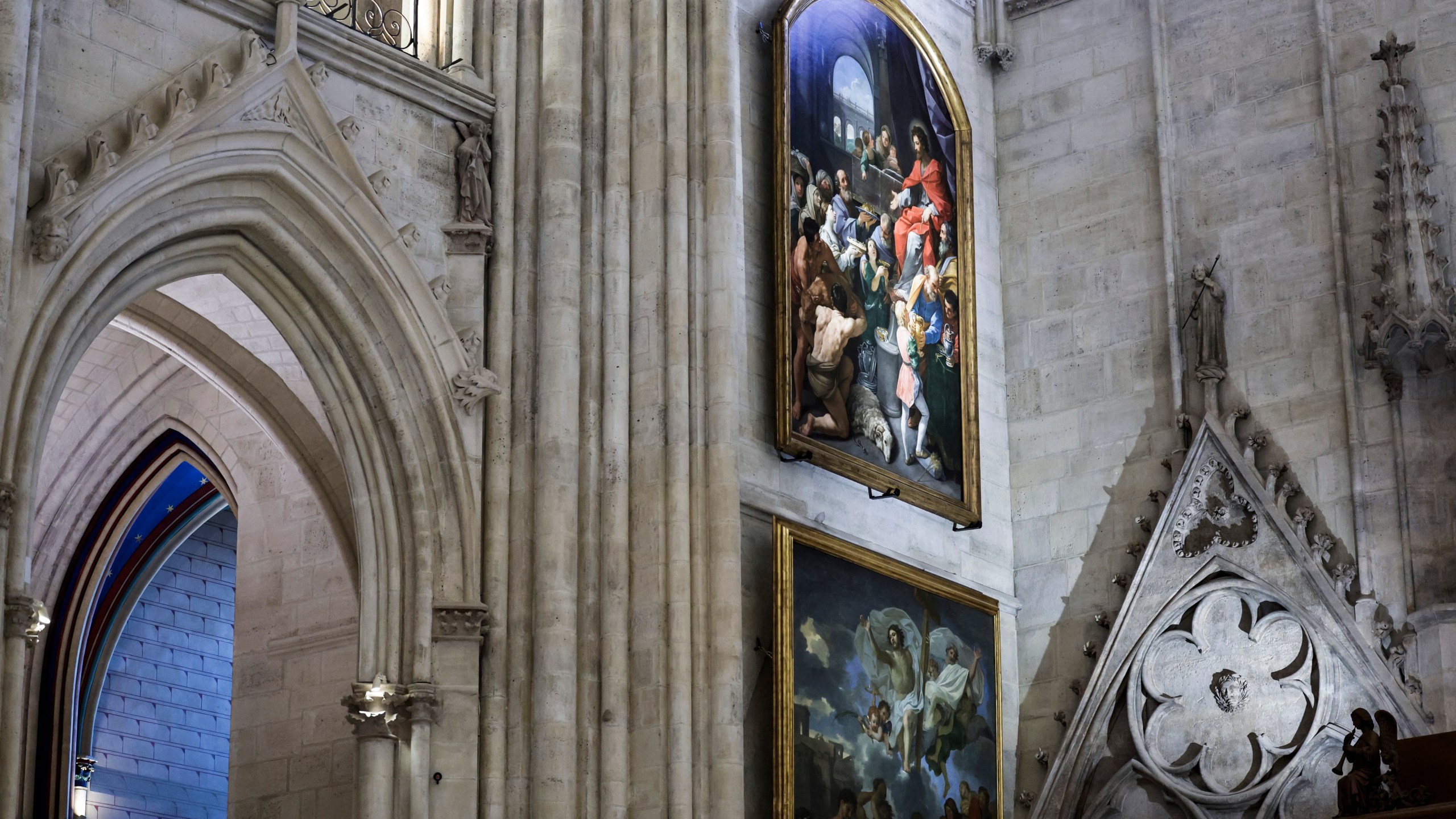 Paintings are seen inside Notre-Dame de Paris cathedral while French President Emmanuel Macron visits the restored interiors of the monument, Friday Nov. 29, 2024, in Paris. (Stephane de Sakutin, Pool via AP)