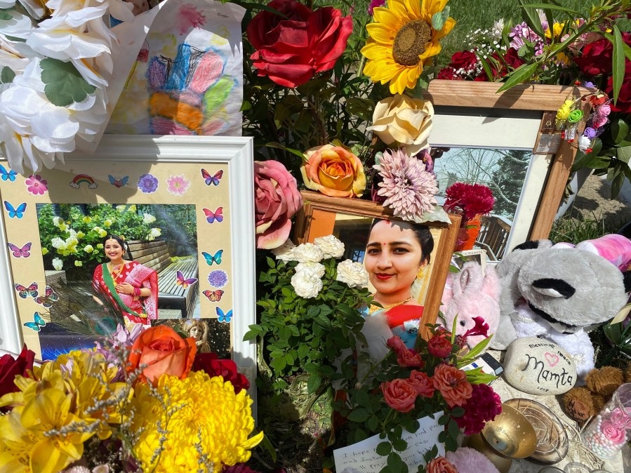 FILE - Flowers, candles and photos are placed near Mamta Kafle Bhatt's mailbox in Manassas Park, Va., Sept. 4, 2024. (AP Photo/Olivia Diaz, File)