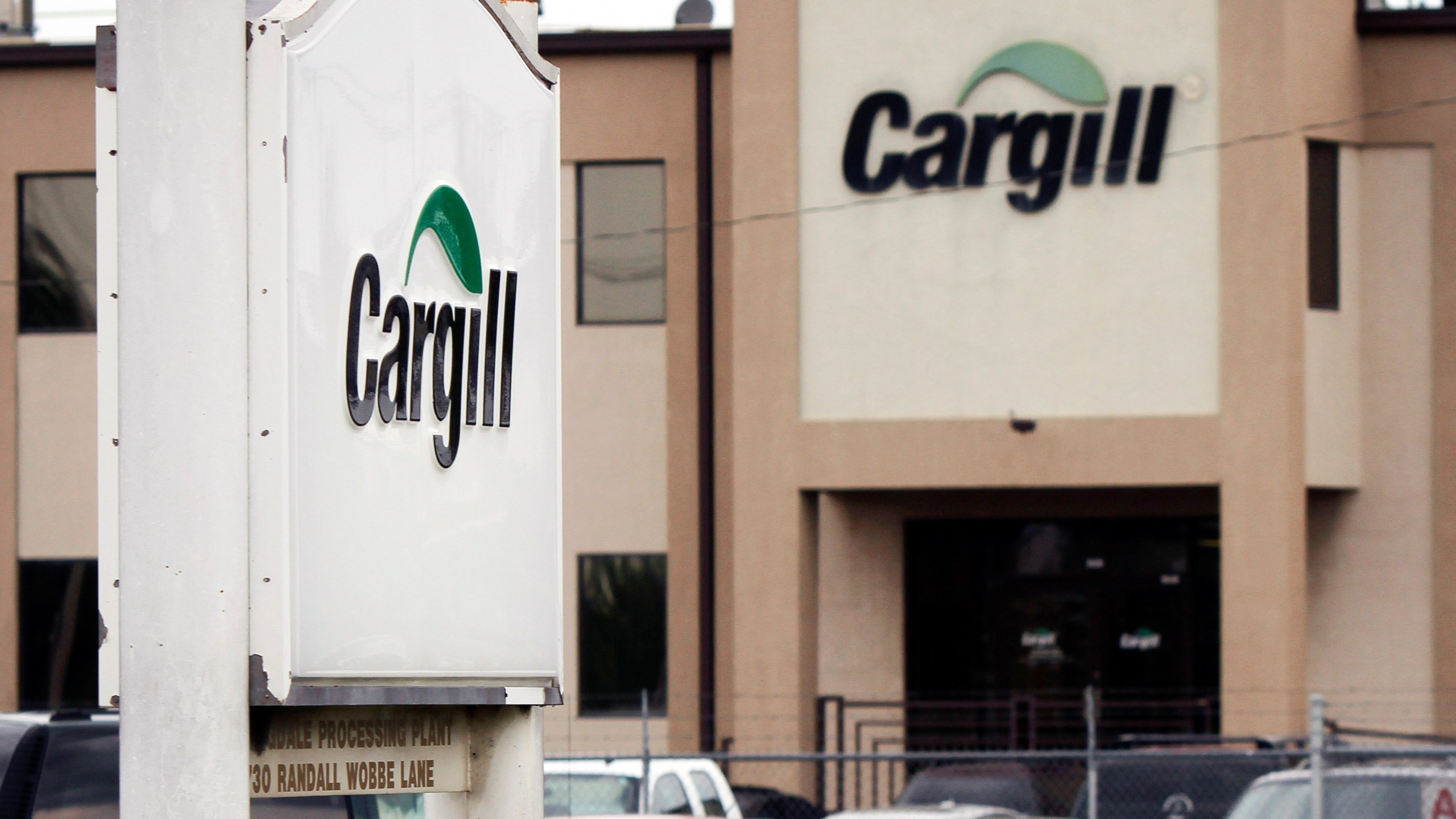 FILE - Cars sit parked at a Cargill Inc., turkey processing plant on Aug. 4, 2011, in Springdale, Ark. (AP Photo/Danny Johnston, File)