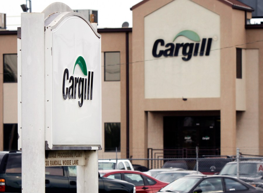 FILE - Cars sit parked at a Cargill Inc., turkey processing plant on Aug. 4, 2011, in Springdale, Ark. (AP Photo/Danny Johnston, File)