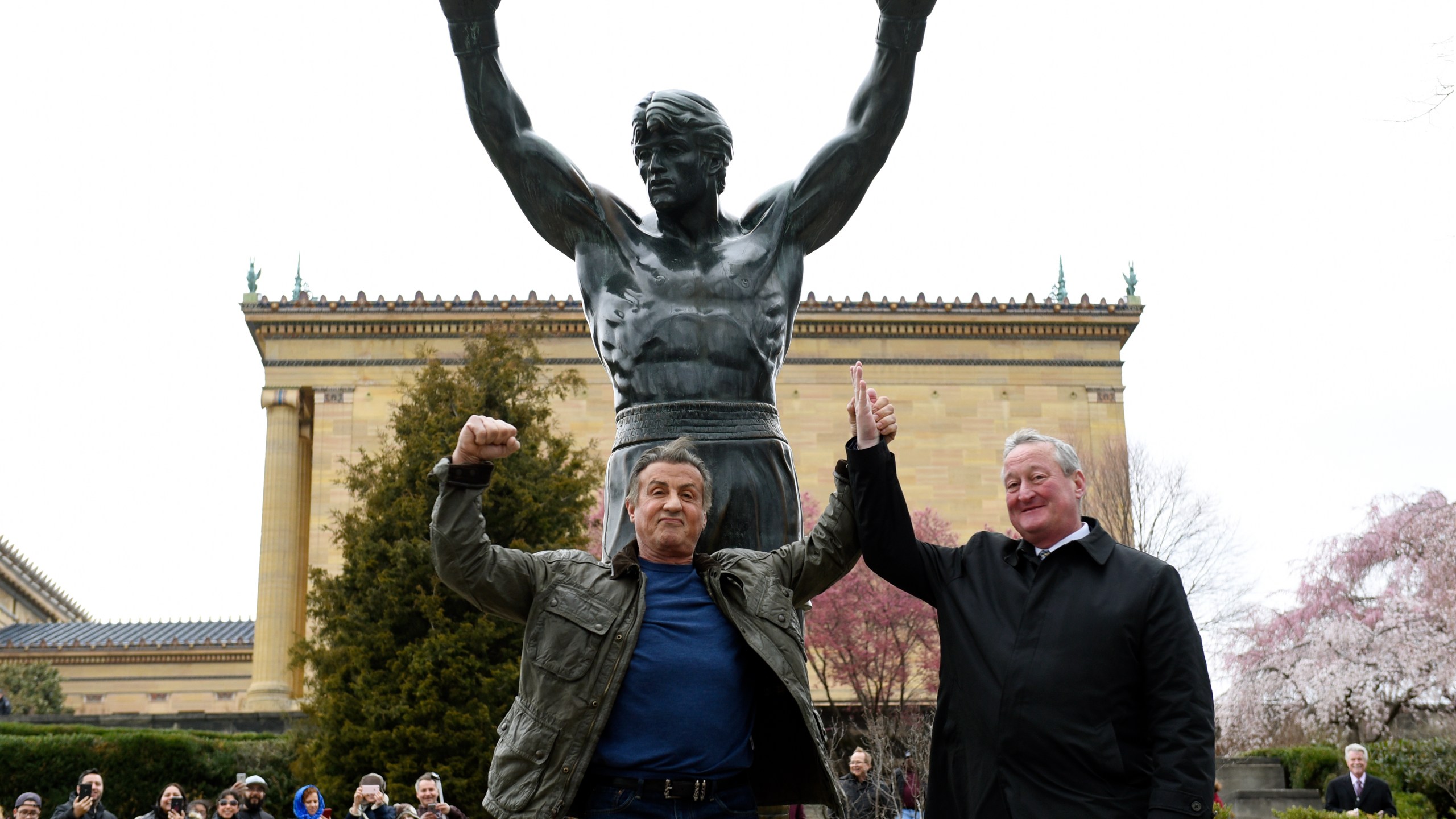 FILE - Sylvester Stallone, left, poses with Philadelphia Mayor Jim Kenney in front of the Rocky statue at the Philadelphia Art Museum for a "Creed II" photo op, Friday, April 6, 2018, in Philadelphia.(AP Photo/Michael Perez)