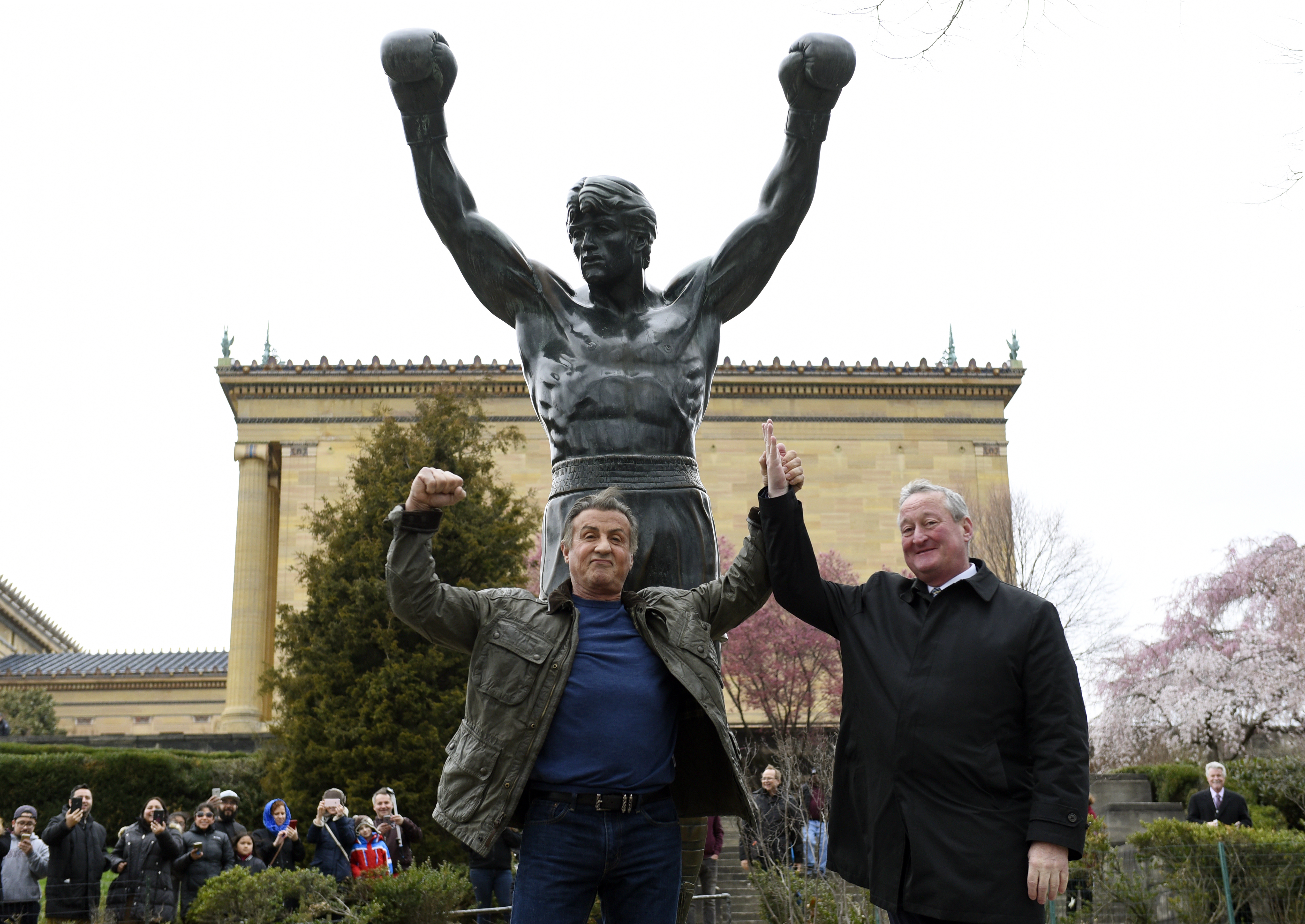 FILE - Sylvester Stallone, left, poses with Philadelphia Mayor Jim Kenney in front of the Rocky statue at the Philadelphia Art Museum for a "Creed II" photo op, Friday, April 6, 2018, in Philadelphia.(AP Photo/Michael Perez)