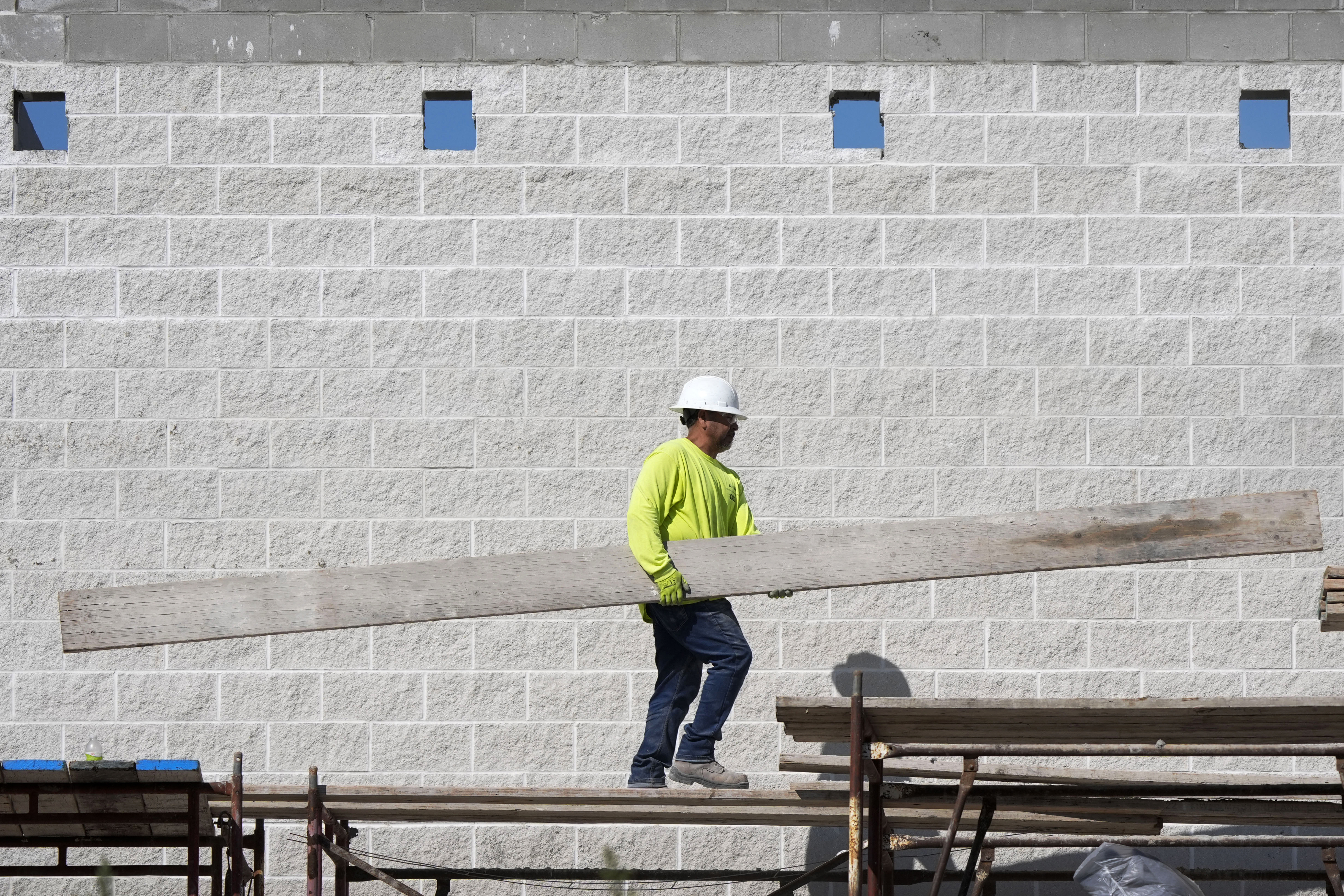 FILE - A construction worker walks on scaffolding at a building site on Sept. 4, 2024, in Waukee, Iowa. (AP Photo/Charlie Neibergall, File)