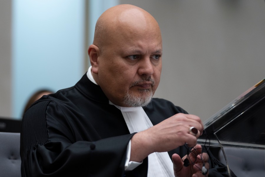 FILE - Public Prosecutor Karim Khan prepares for the trial of Mahamat Said Abdel Kani at the International Criminal Court in The Hague, Netherlands, Sept. 26, 2022. (AP Photo/Peter Dejong, Pool, File)