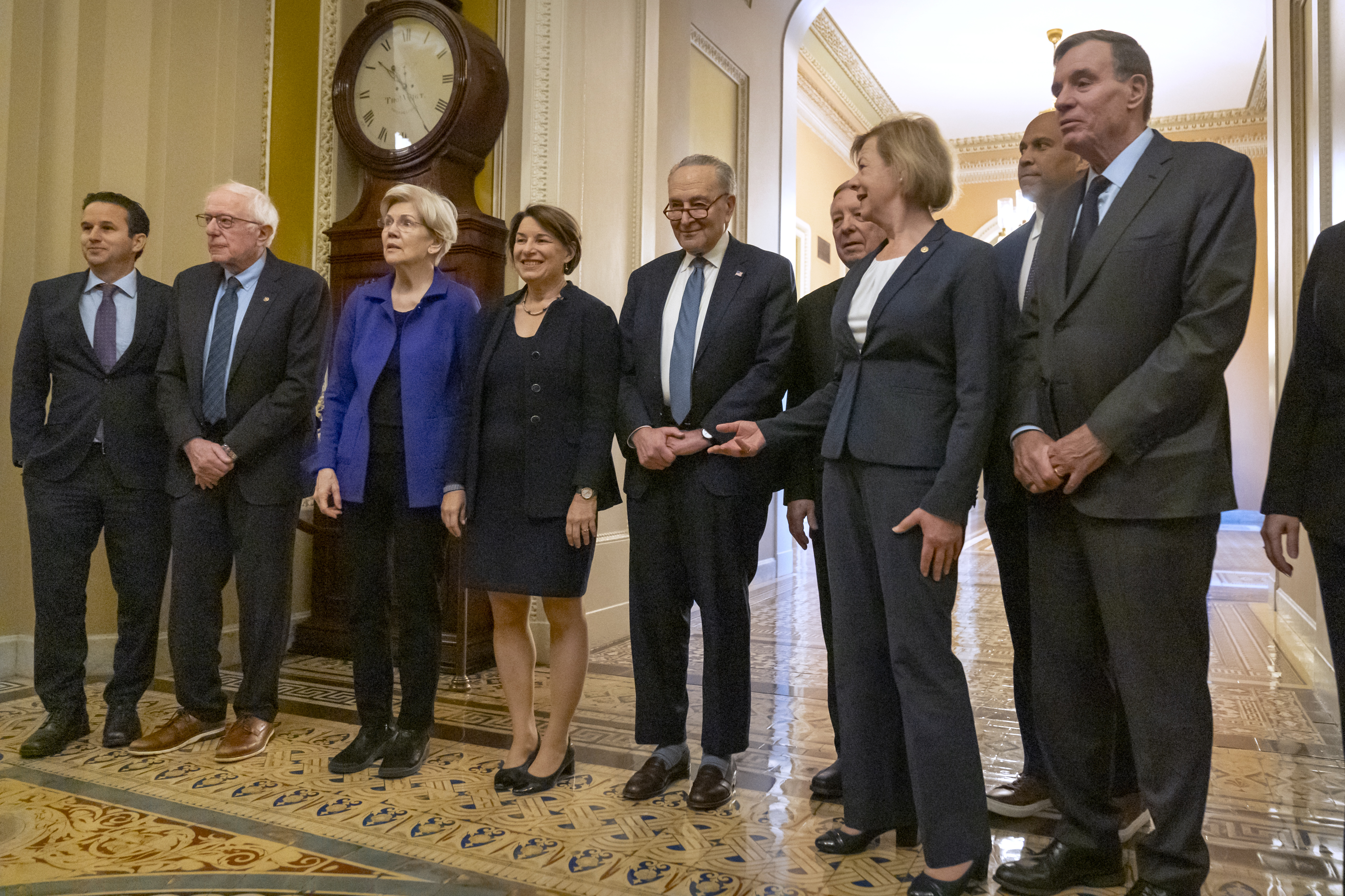 Senators, from left, Sen. Brian Schatz, D-Hawaii, Sen. Bernie Sanders, I-Vt., Sen. Elizabeth Warren, D-Mass., Sen. Amy Klobuchar, D-Minn., Senate Majority Leader Chuck Schumer of N.Y., Sen. Dick Durbin, D-Ill., Sen. Tammy Baldwin, D-Wis., Sen. Cory Booker, D-N.J., and Sen. Mark Warner, D-Va., gather after Senate Democratic leadership elections for the next session of Congress on Capitol Hill, Tuesday, Dec. 3, 2024, in Washington. (AP Photo/Mark Schiefelbein)