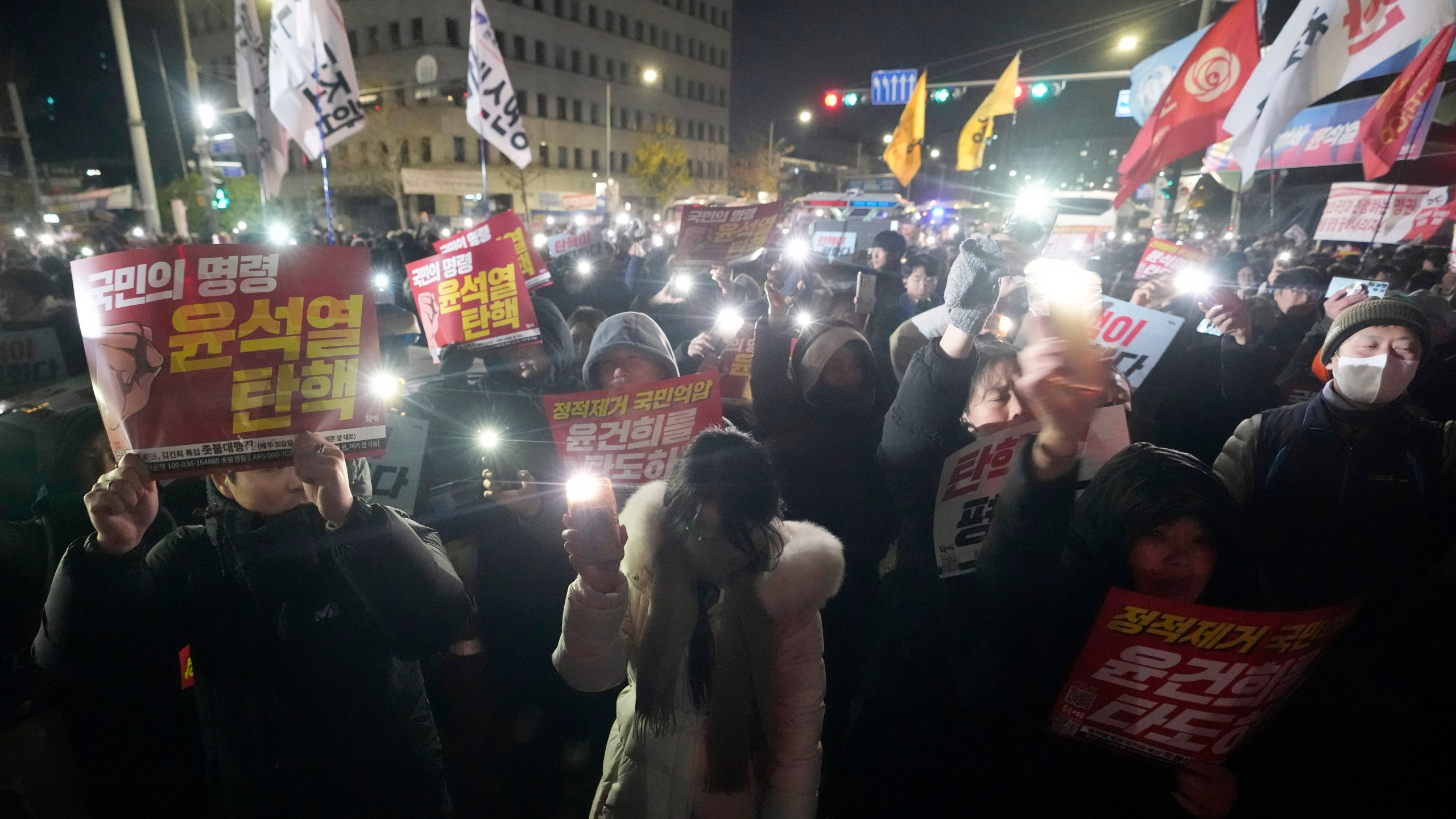 People gather to demand South Korean President Yoon Suk Yeol to step down in front of the National Assembly in Seoul, South Korea, Wednesday, Dec. 4, 2024. (AP Photo/Ahn Young-joon)