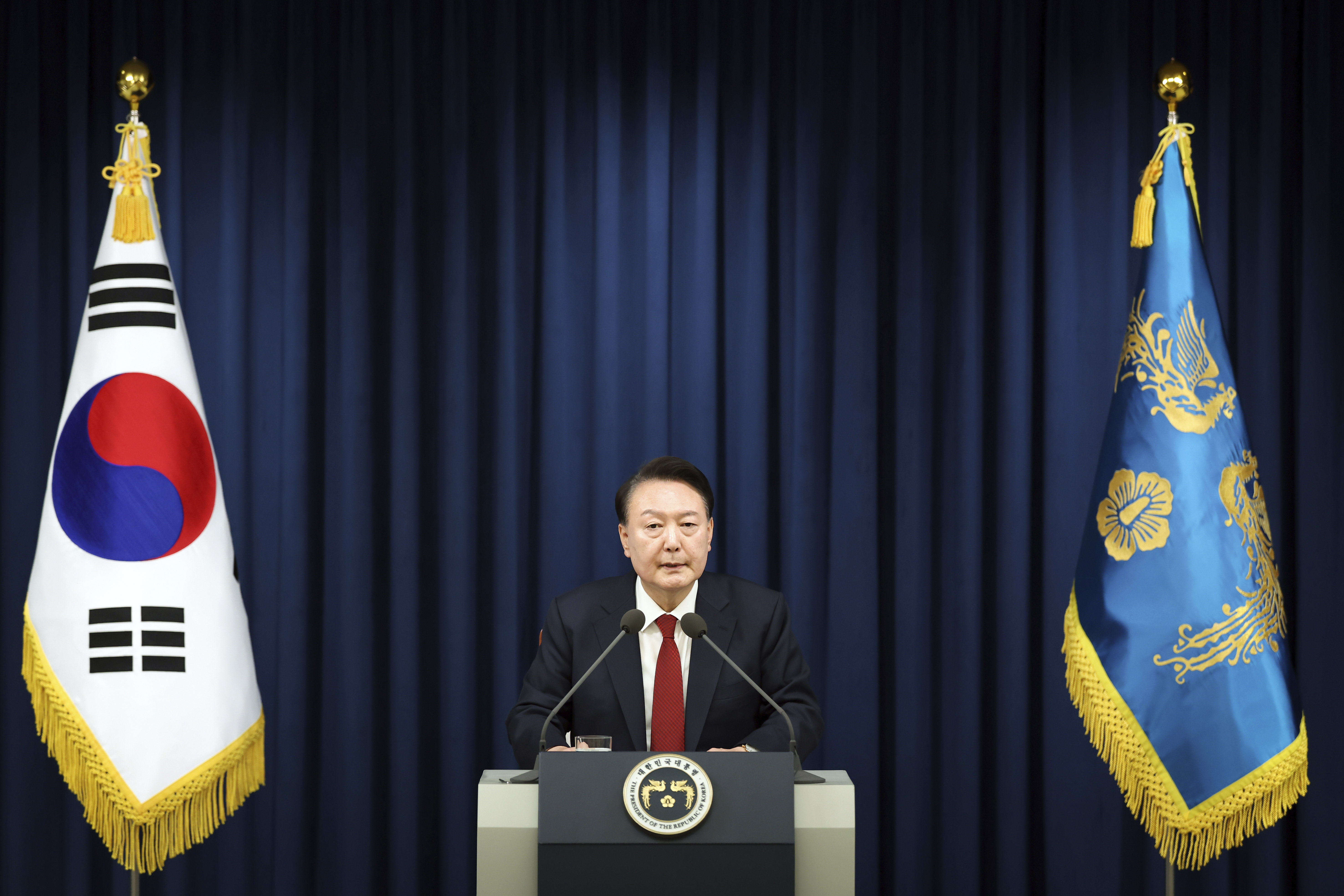 In this photo provided by South Korea Presidential Office, South Korean President Yoon Suk Yeol speaks during a press briefing at the presidential office in Seoul, South Korea, Tuesday, Dec. 3, 2024. (South Korea Unification Ministry via AP).