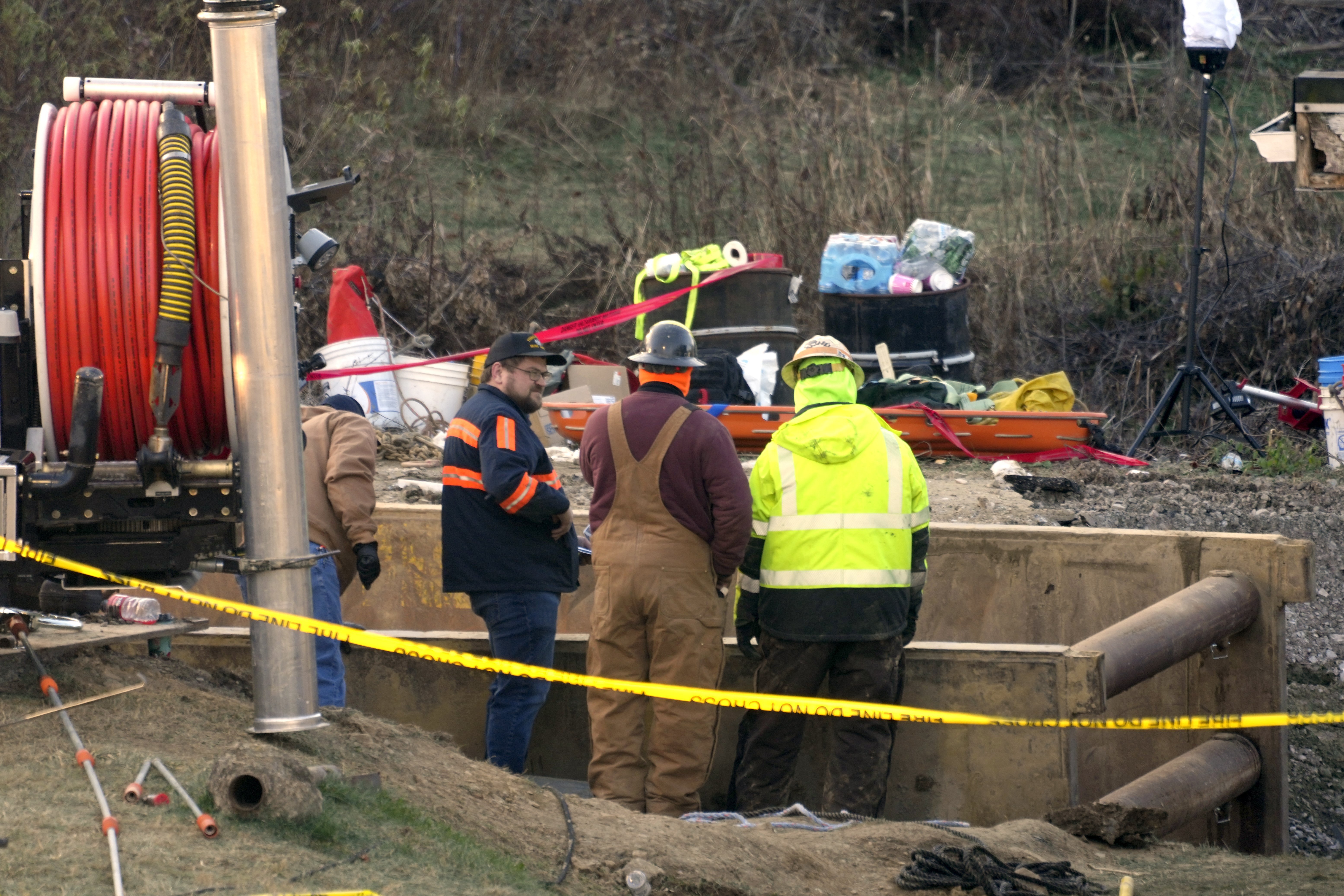 Rescue workers continue to search, Wednesday, Dec. 4, 2024, for Elizabeth Pollard, who is believed to have disappeared in a sinkhole while looking for her cat, in Marguerite, Pa. (AP Photo/Gene J. Puskar)