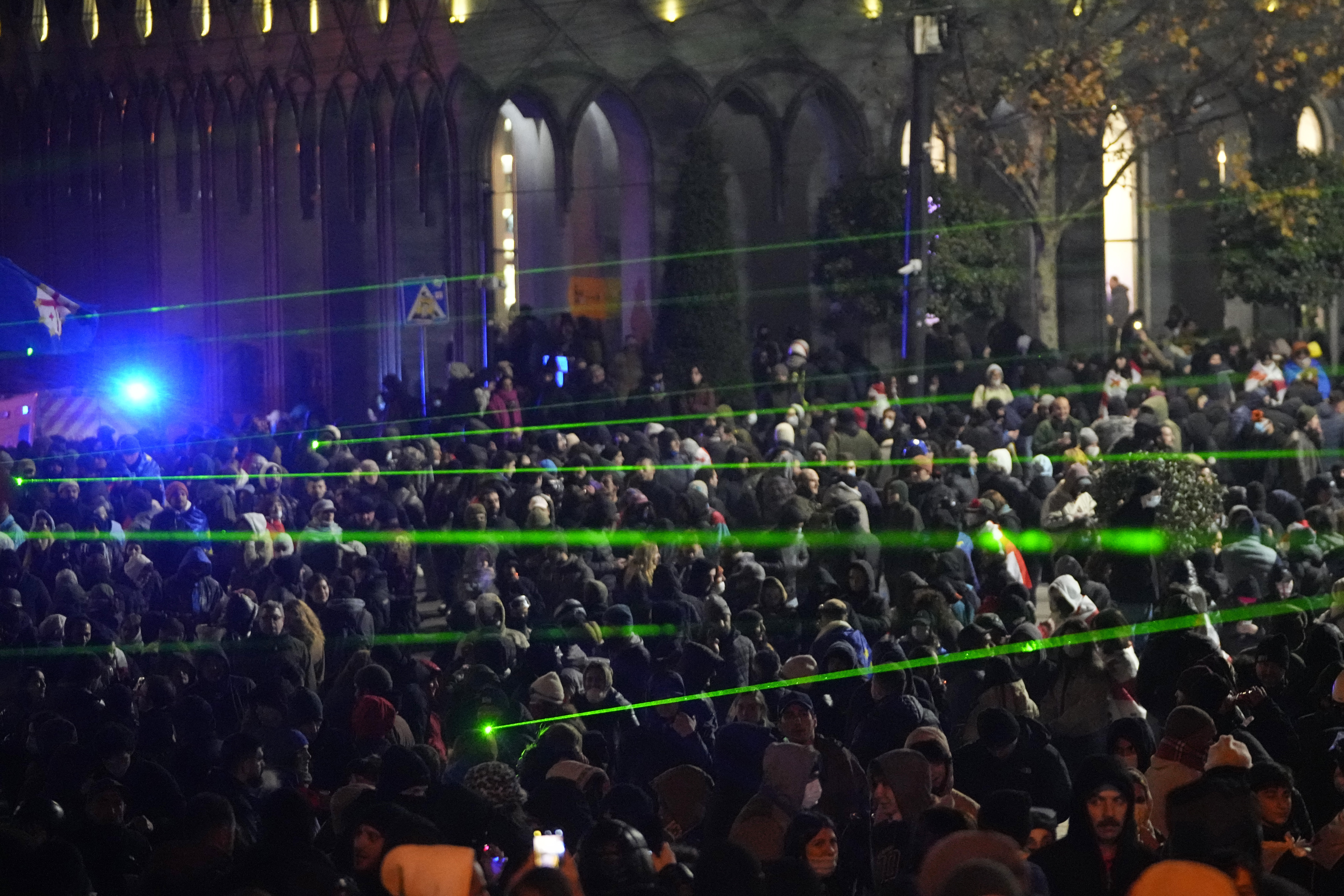 Demonstrators use lasers against the police during a rally outside the parliament building to protests against the government's decision to suspend negotiations on joining the European Union in Tbilisi, Georgia, on Wednesday, Dec. 4, 2024. (AP Photo/Pavel Bednyakov)