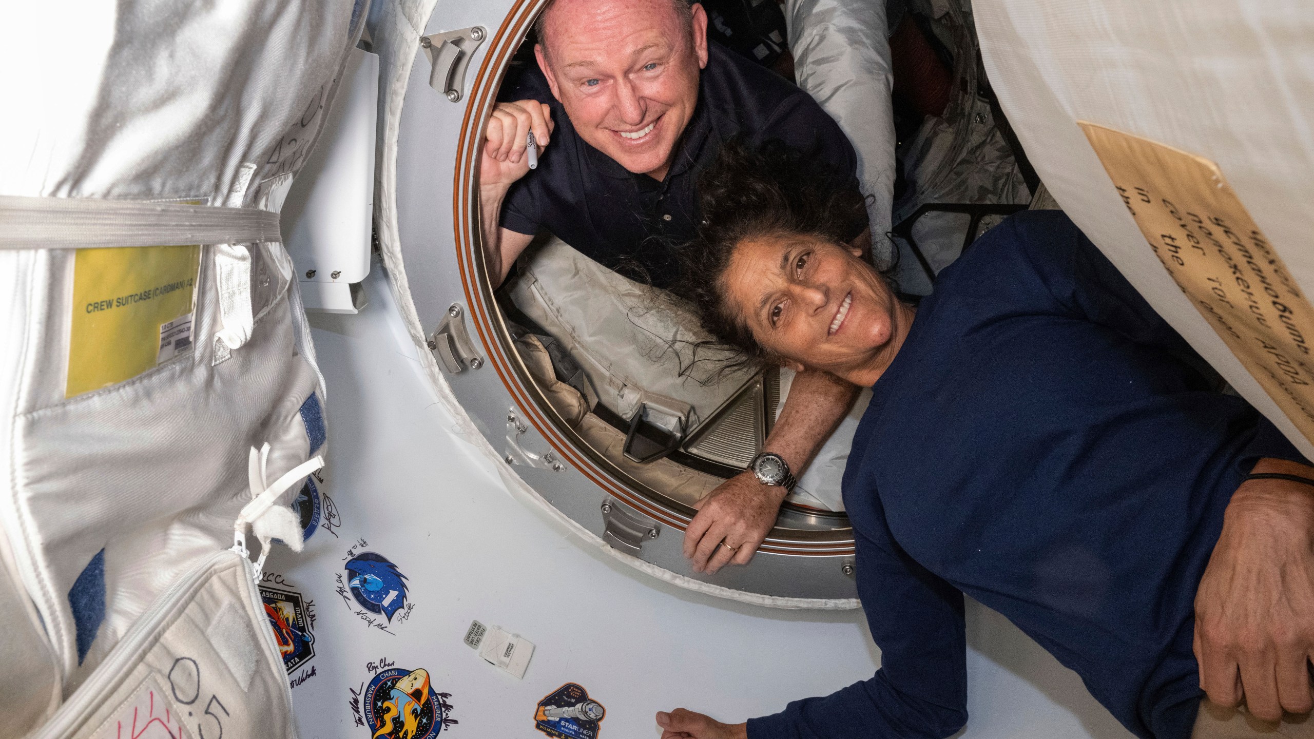 FILE - In this photo provided by NASA, Boeing Crew Flight Test astronauts Butch Wilmore, left, and Suni Williams pose for a portrait inside the vestibule between the forward port on the International Space Station's Harmony module and Boeing's Starliner spacecraft on June 13, 2024. (NASA via AP, File)