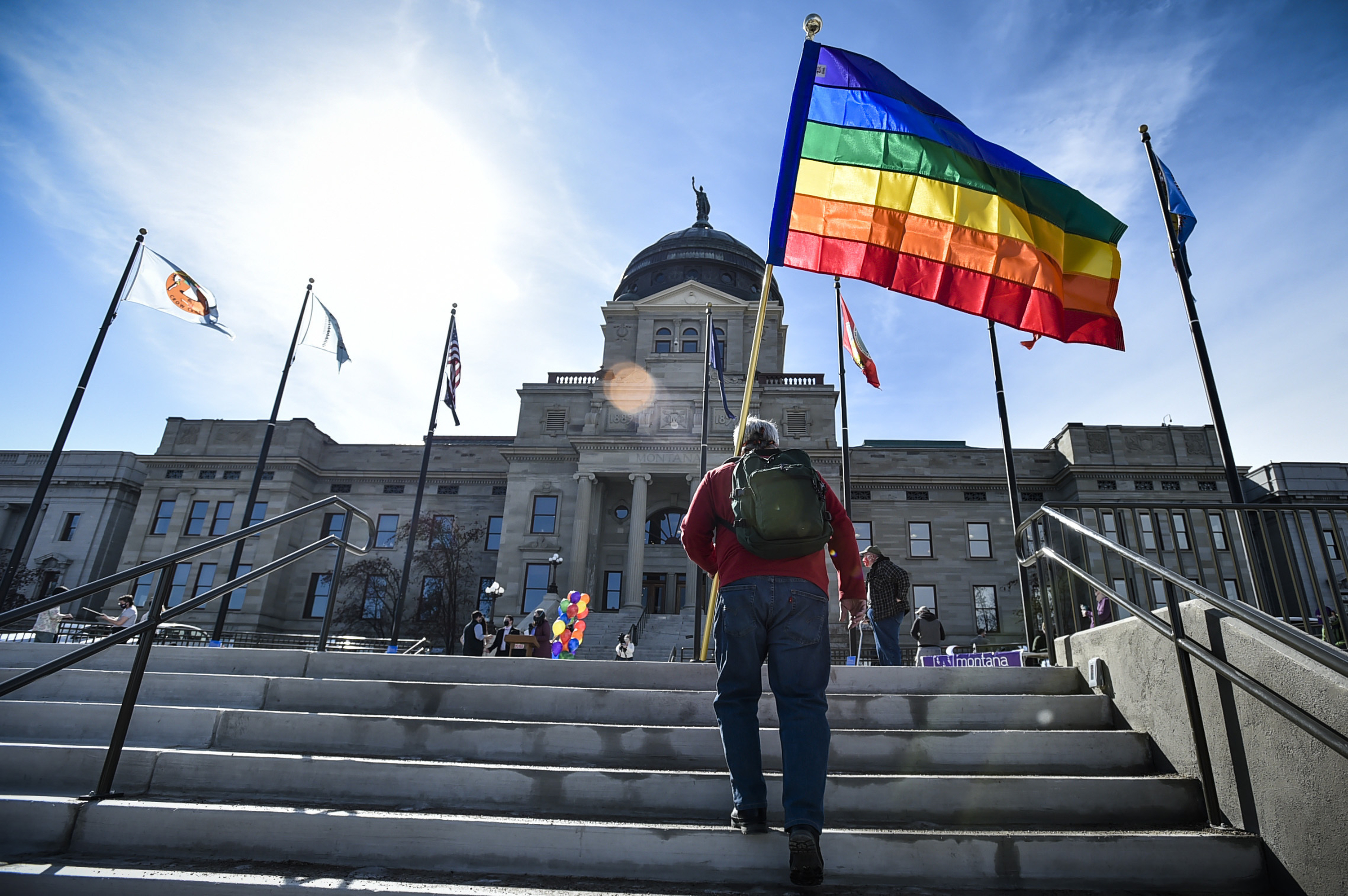 FILE - Demonstrators gather on the steps of the Montana state Capitol protesting anti-LGBTQ+ legislation in Helena, Mont., March 15, 2021. (Thom Bridge/Independent Record via AP, File)