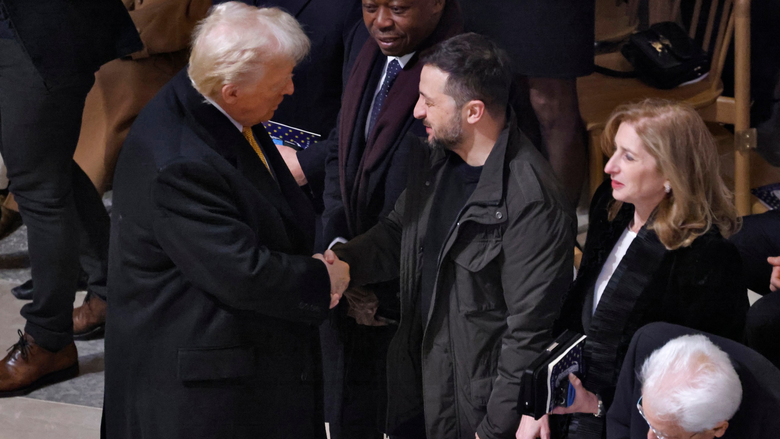 President-elect Donald Trump shakes hands with Ukraine's President Volodymyr Zelenskyy in Notre Dame Cathedral as France's iconic cathedral is formally reopening its doors for the first time since a devastating fire nearly destroyed the 861-year-old landmark in 2019, Saturday Dec.7, 2024 in Paris ( Ludovic Marin, Pool via AP)