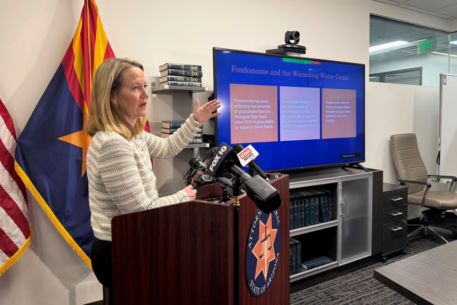 Arizona Attorney General Kris Mayes announces she's suing a Saudi Arabian company for allegedly pumping groundwater that harms local communities in a rural western county, Wednesday, Dec. 11, 2024, in Phoenix. (AP Photo/Gabriel Sandoval)