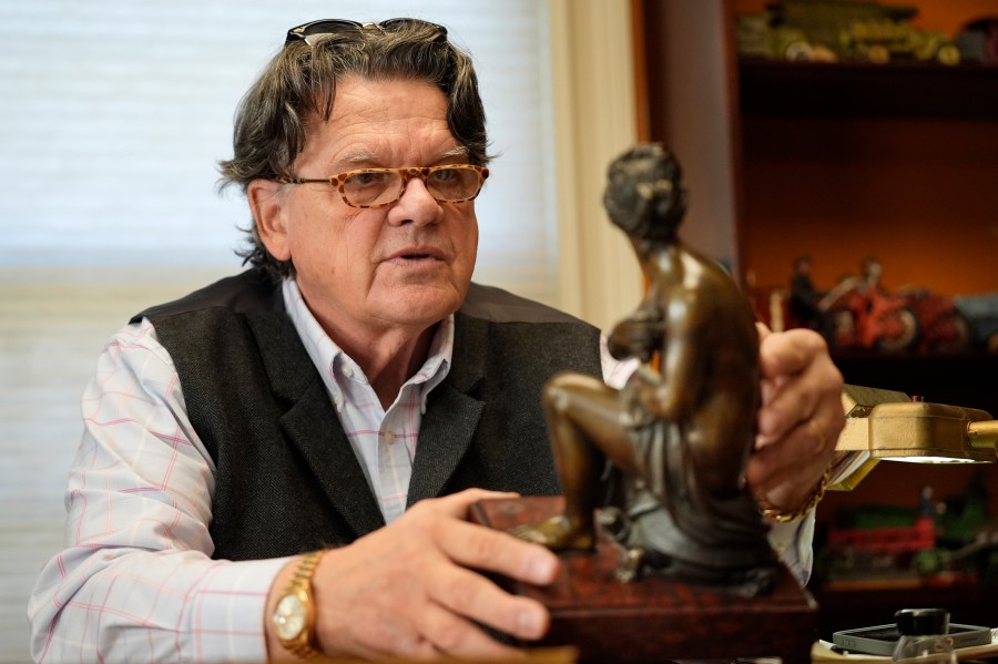 Appraiser Kaja Veilleux inspects a bronze piece for a client at Thomaston Place Auction Galleries, Tuesday, Nov. 19, 2024, in Thomaston, Maine. (AP Photo/Robert F. Bukaty)