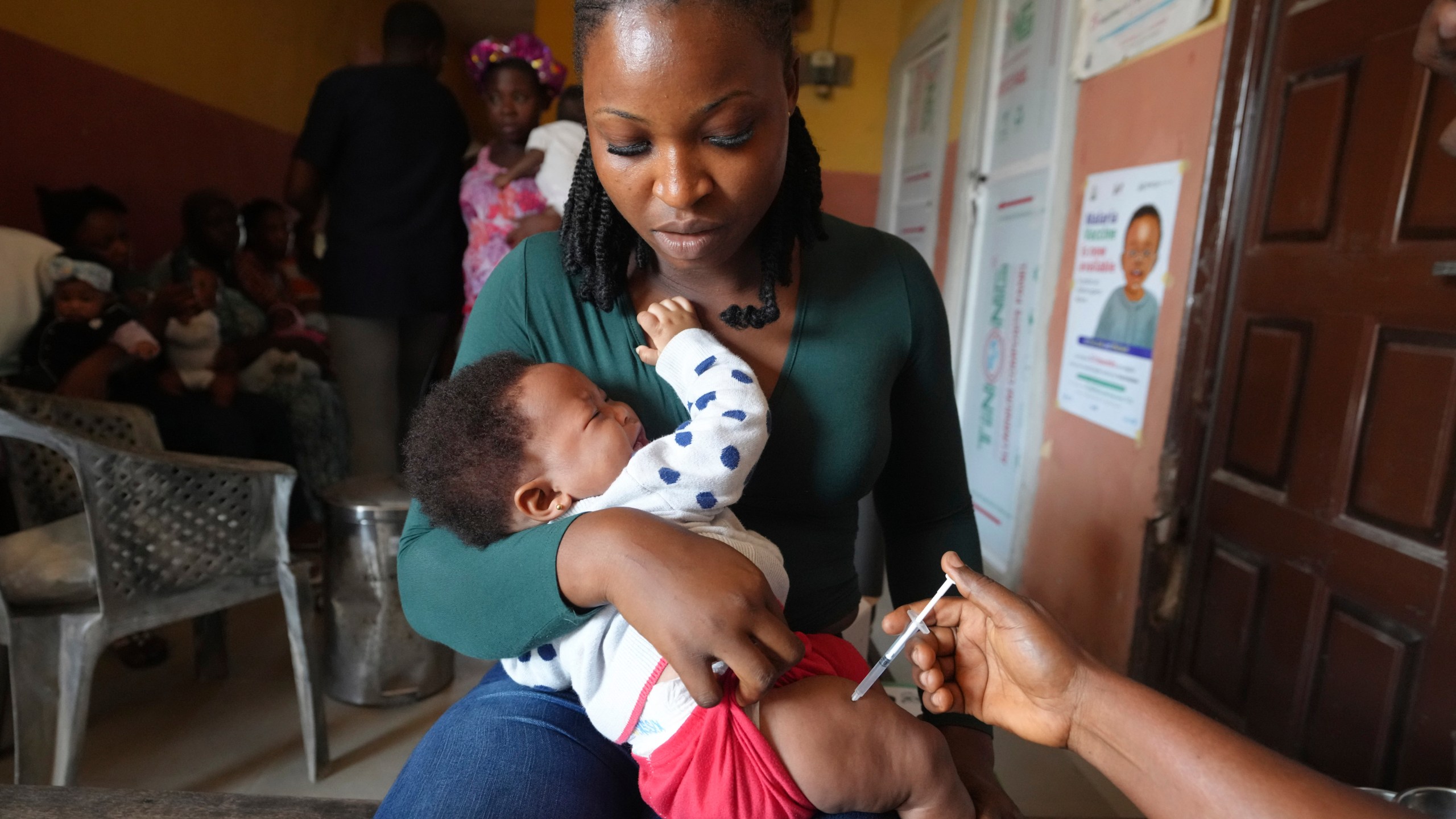 A health worker administers the malaria vaccine R21/Matrix-M to a child at the comprehensive Health Centre in Agudama-Epie, in Yenagoa, Nigeria, Monday, Dec. 9, 2024. (AP Photo/Sunday Alamba)