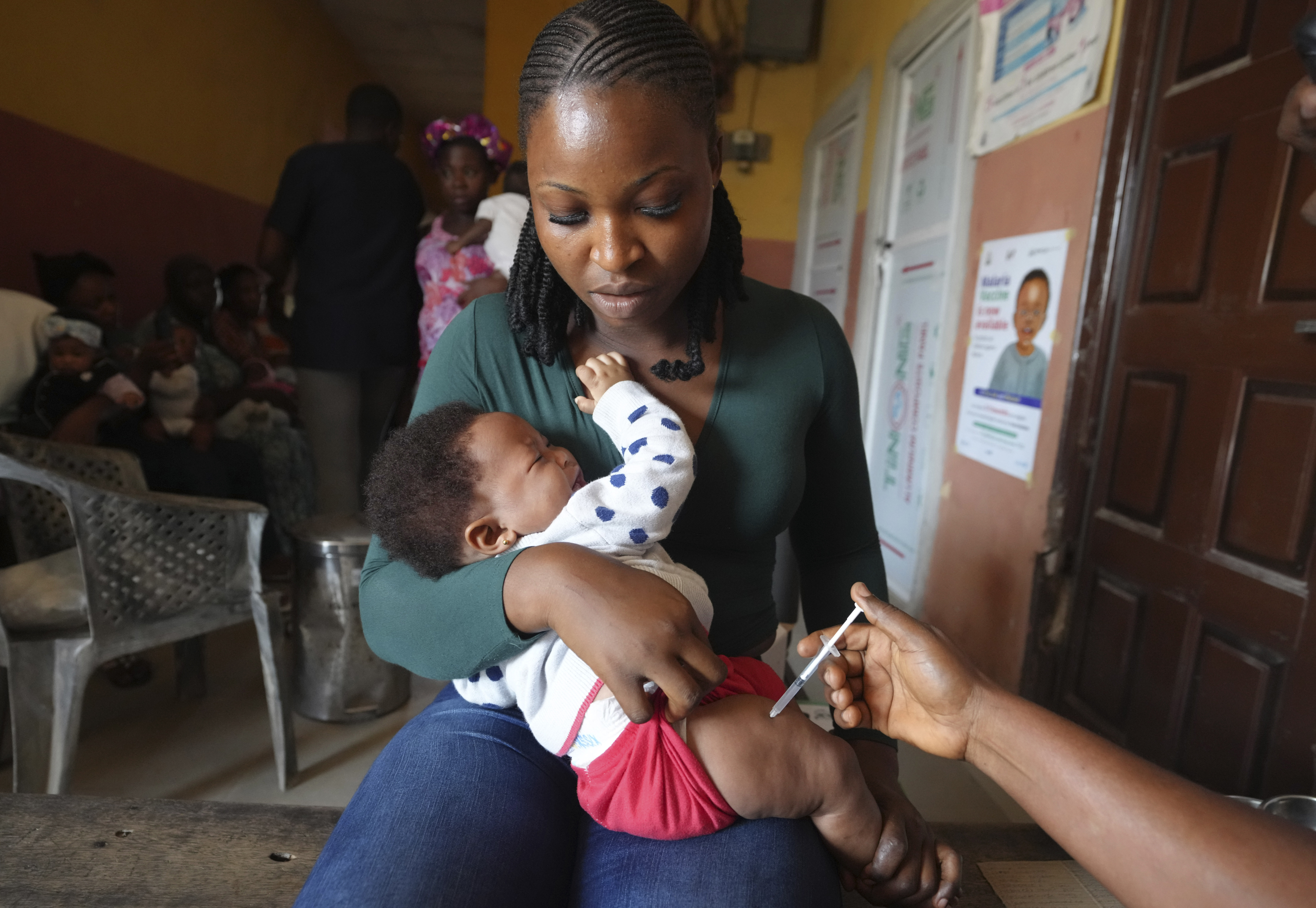 A health worker administers the malaria vaccine R21/Matrix-M to a child at the comprehensive Health Centre in Agudama-Epie, in Yenagoa, Nigeria, Monday, Dec. 9, 2024. (AP Photo/Sunday Alamba)