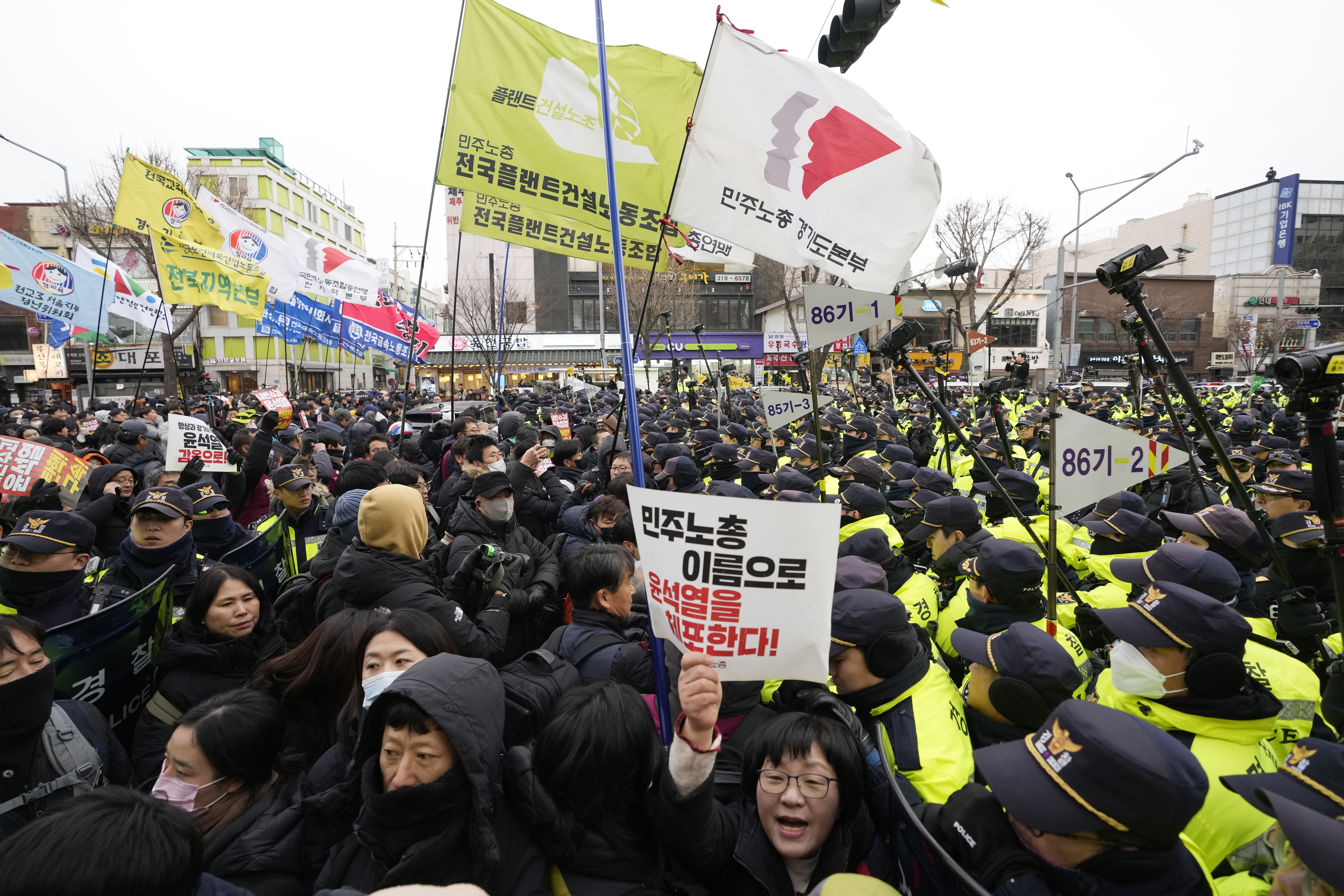 Protesters struggle with police officers as they march to the presidential office after a rally demanding South Korean President Yoon Suk Yeol's impeachment in Seoul, South Korea, Thursday, Dec. 12, 2024. (AP Photo/Ahn Young-joon)