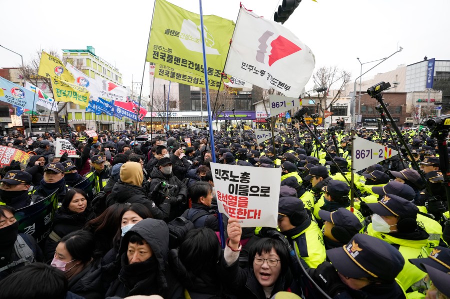 Protesters struggle with police officers as they march to the presidential office after a rally demanding South Korean President Yoon Suk Yeol's impeachment in Seoul, South Korea, Thursday, Dec. 12, 2024. (AP Photo/Ahn Young-joon)