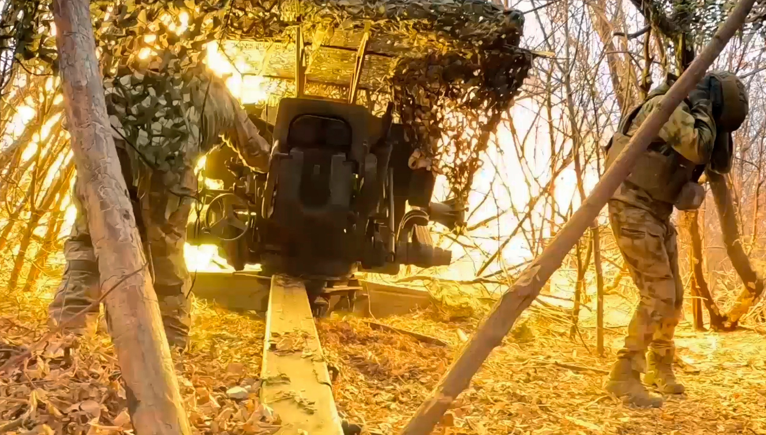 In this photo taken from a video released by Russian Defense Ministry press service on Wednesday, Dec. 11, 2024, Russian servicemen fire a D-20 howitzer towards Ukrainian positions in an undisclosed location. (Russian Defense Ministry Press Service via AP)