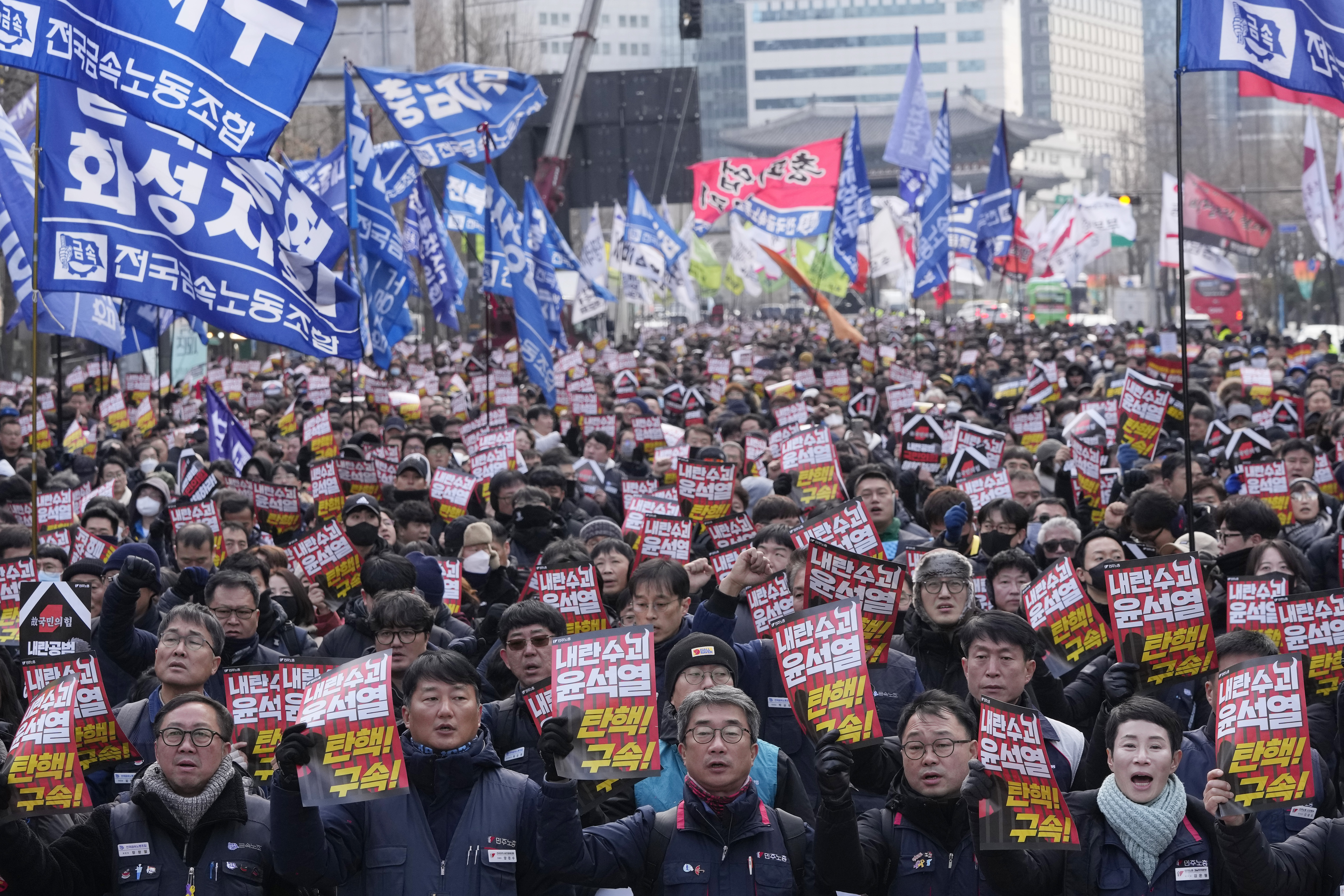 Protesters stage a rally demanding South Korean President Yoon Suk Yeol's impeachment in Seoul, South Korea, Thursday, Dec. 12, 2024. The signs read "Arrest the rebellion leader Yoon Suk Yeol." (AP Photo/Ahn Young-joon)