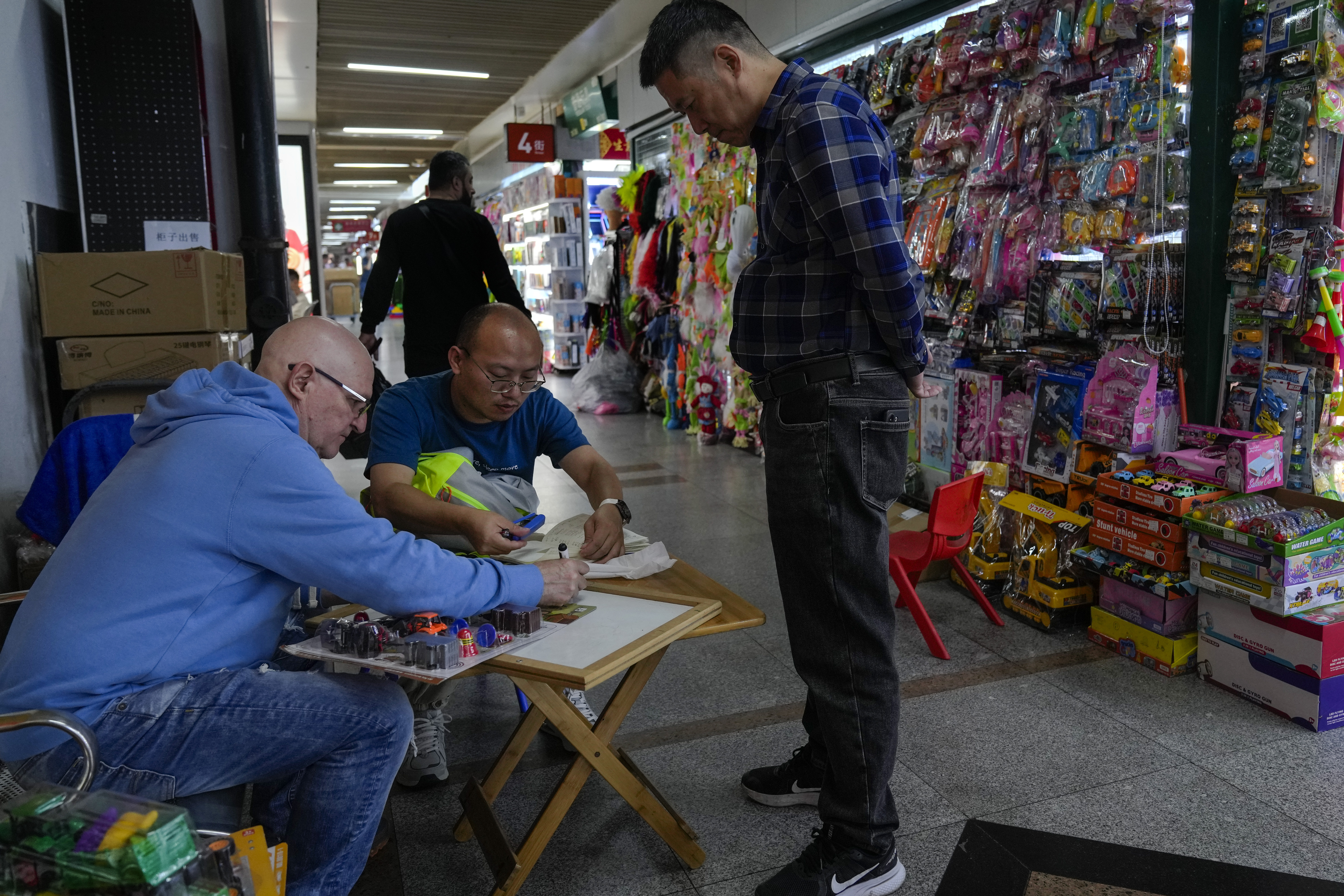 A foreign buyer bargains toys prices with a vendor at the Yiwu wholesale market in Yiwu, east China's Zhejiang province on Nov. 8, 2024. (AP Photo/Andy Wong)