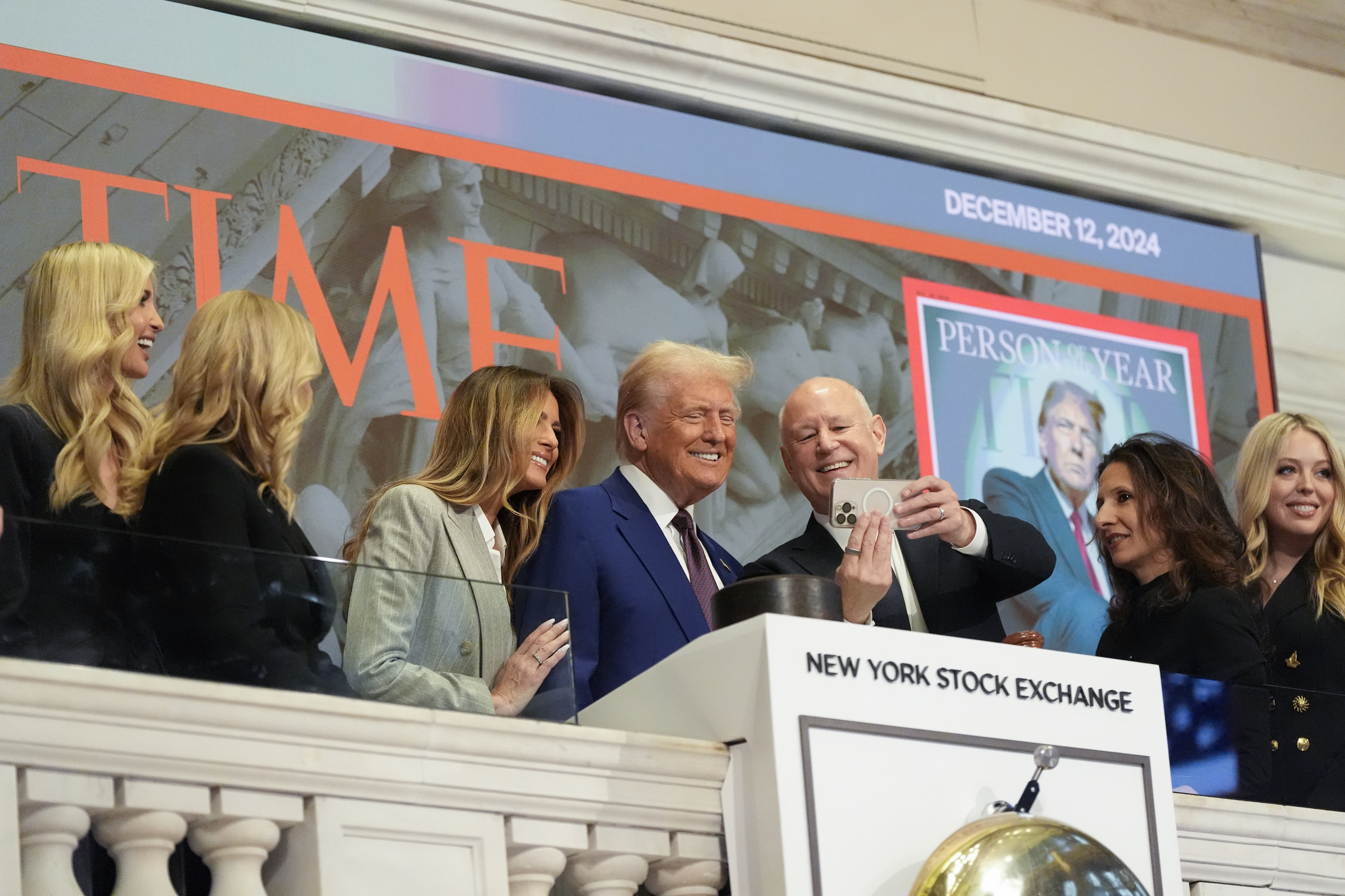 President-elect Donald Trump stands for a selfie after ringing the opening bell at the New York Stock Exchange, Thursday, Dec. 12, 2024, in New York. (AP Photo/Alex Brandon)