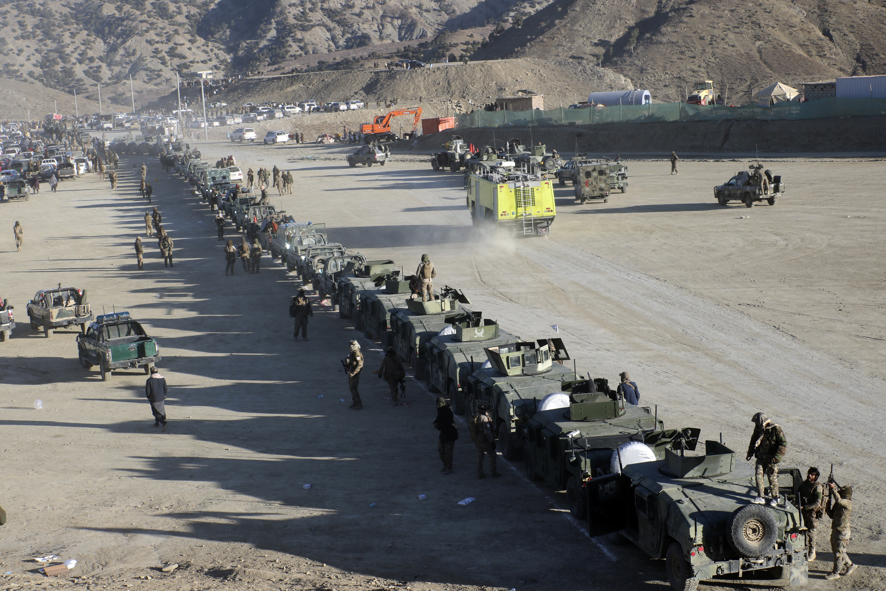 Taliban fighters stand guard during the funeral prayers of Khalil Haqqani, the minister for refugees and repatriation, during his funeral procession in eastern Paktia province, Afghanistan, Thursday, Dec. 12, 2024. (AP Photo/Saifullah Zahir)