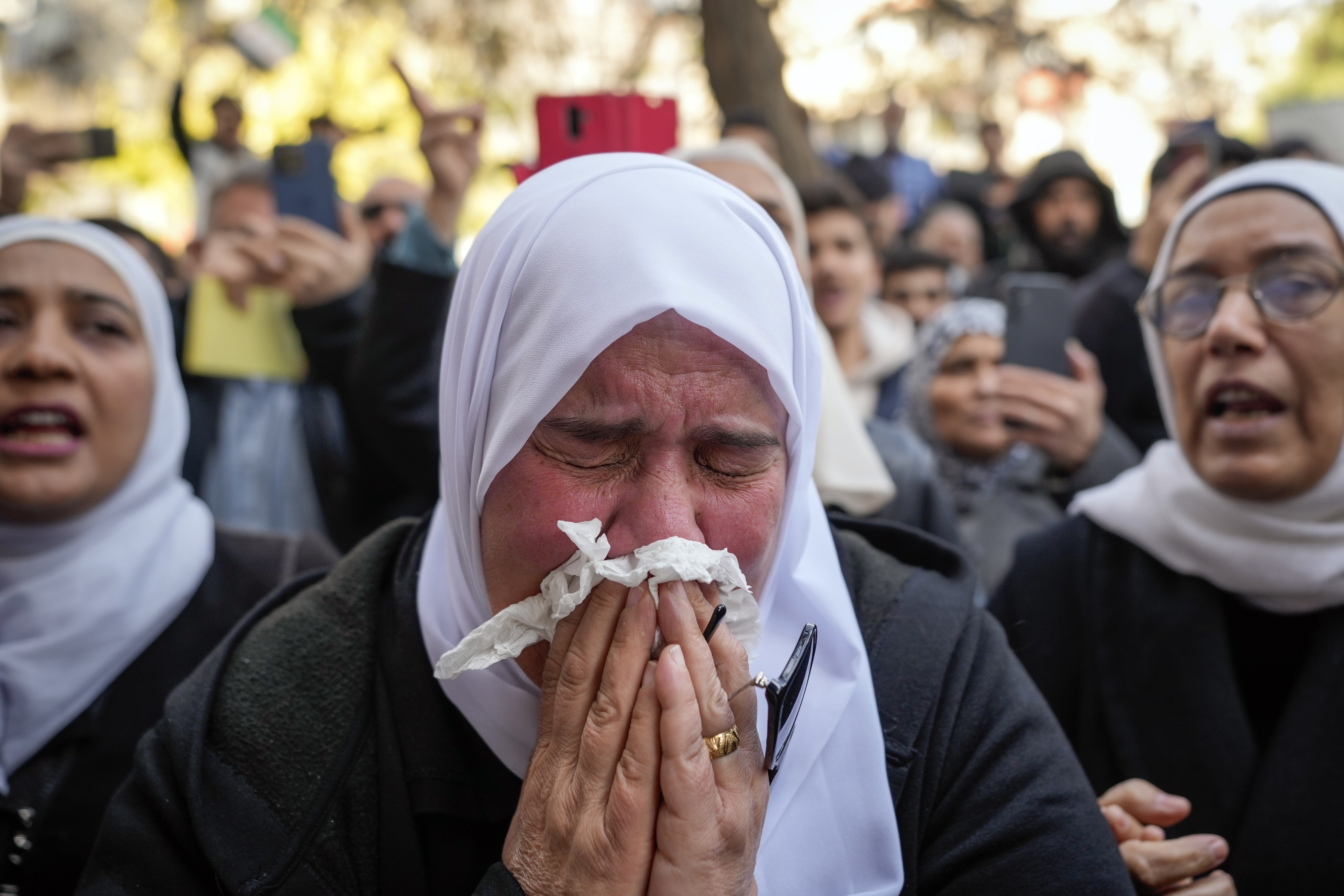 A woman weeps during the funeral of Syrian activist Mazen al-Hamada in Damascus, Thursday, Dec. 12, 2024. Al-Hamad's mangled corpse was found wrapped in a bloody sheet in Saydnaya prison. He had fled to Europe but returned to Syria in 2020 and was imprisoned upon arrival. (AP Photo/Hussein Malla)