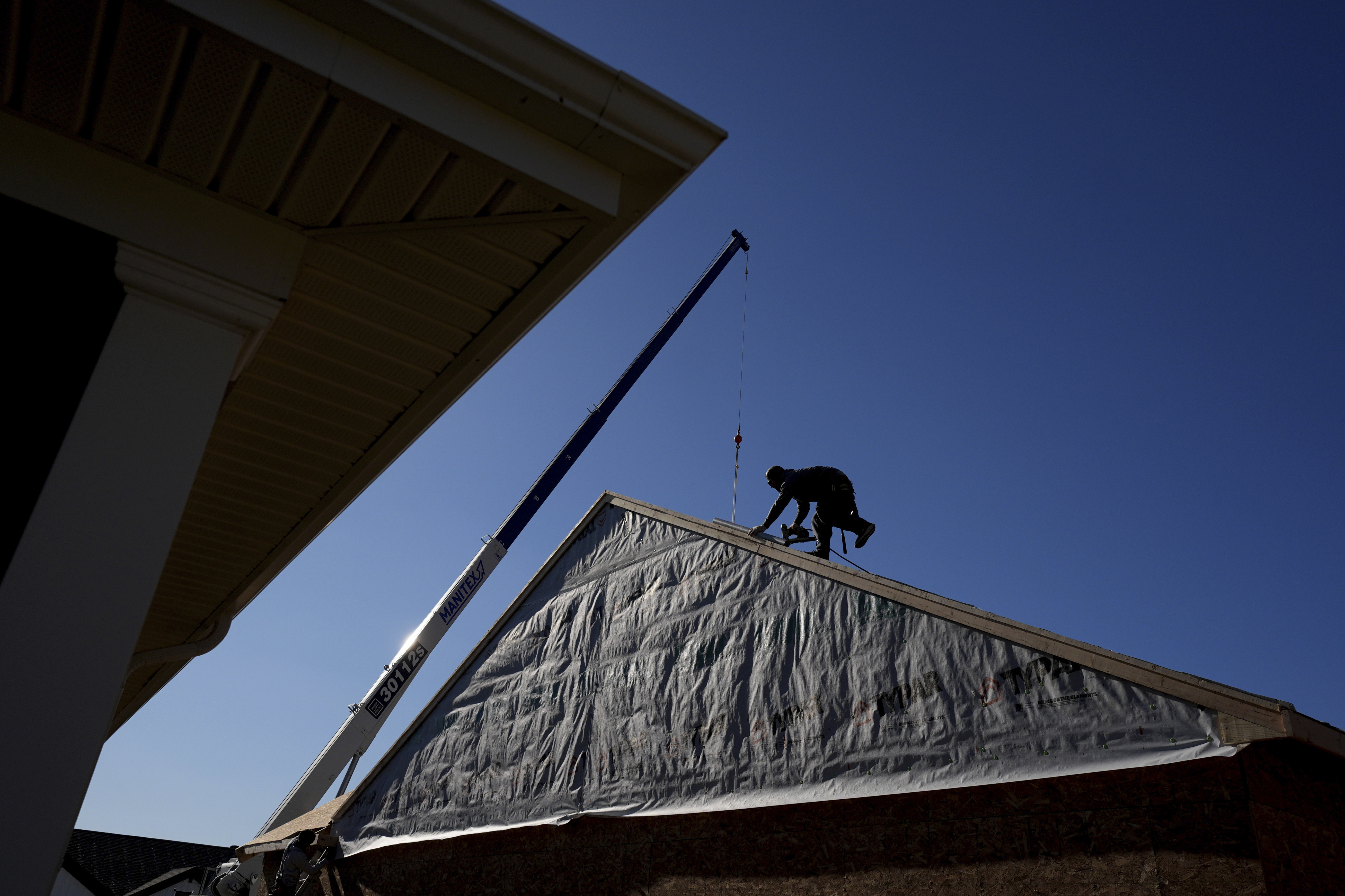 Construction workers frame a new single-family home Friday, Dec. 6, 2024, in Owensboro, Ky. (AP Photo/Charlie Riedel)